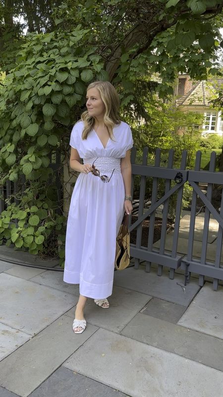A classic white dress and a straw bag for summer 