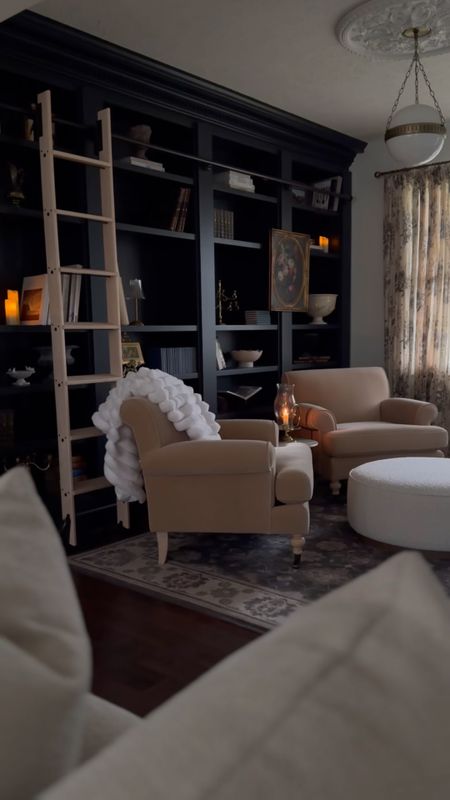 Shop my moody library living room space with cozy accent chairs, and stunning home decor pieces!  #homedecor #livingroom #moody #amazonfinds #accentchair #rugs #cabinet

#LTKhome