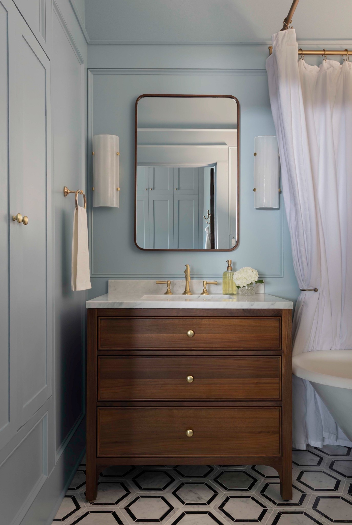 Blue bathroom makeover! I love how the walnut and brass accents add life back into this color-washed room 🩵

#LTKHome