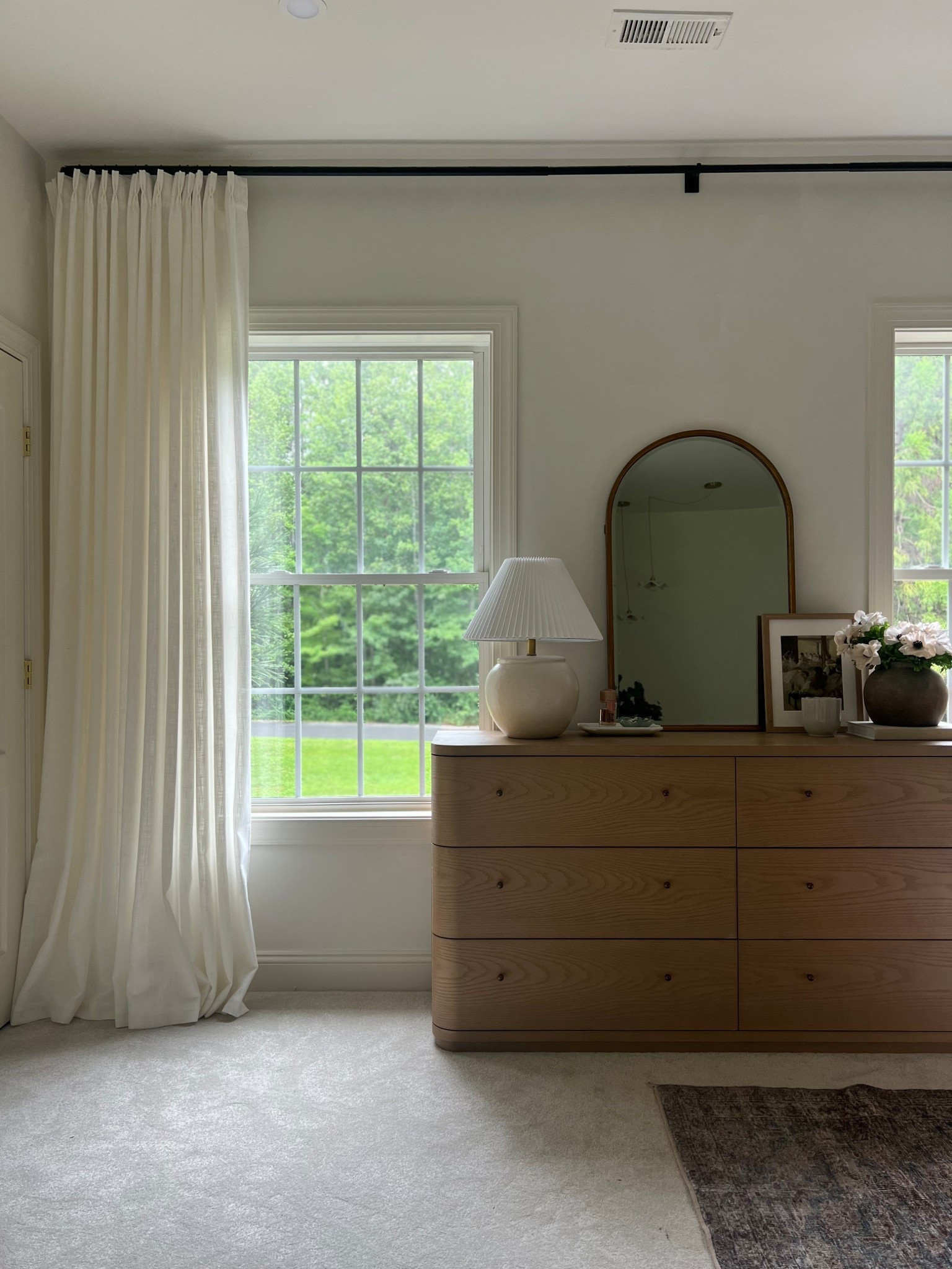 Pinch pleat drapes in natural linen.
For an elevated look use French return rods.
For practical use apply glide tape to the top of your curtain rods and stitch two panels together so they appear as one large panel.

Color is natural without a liner.