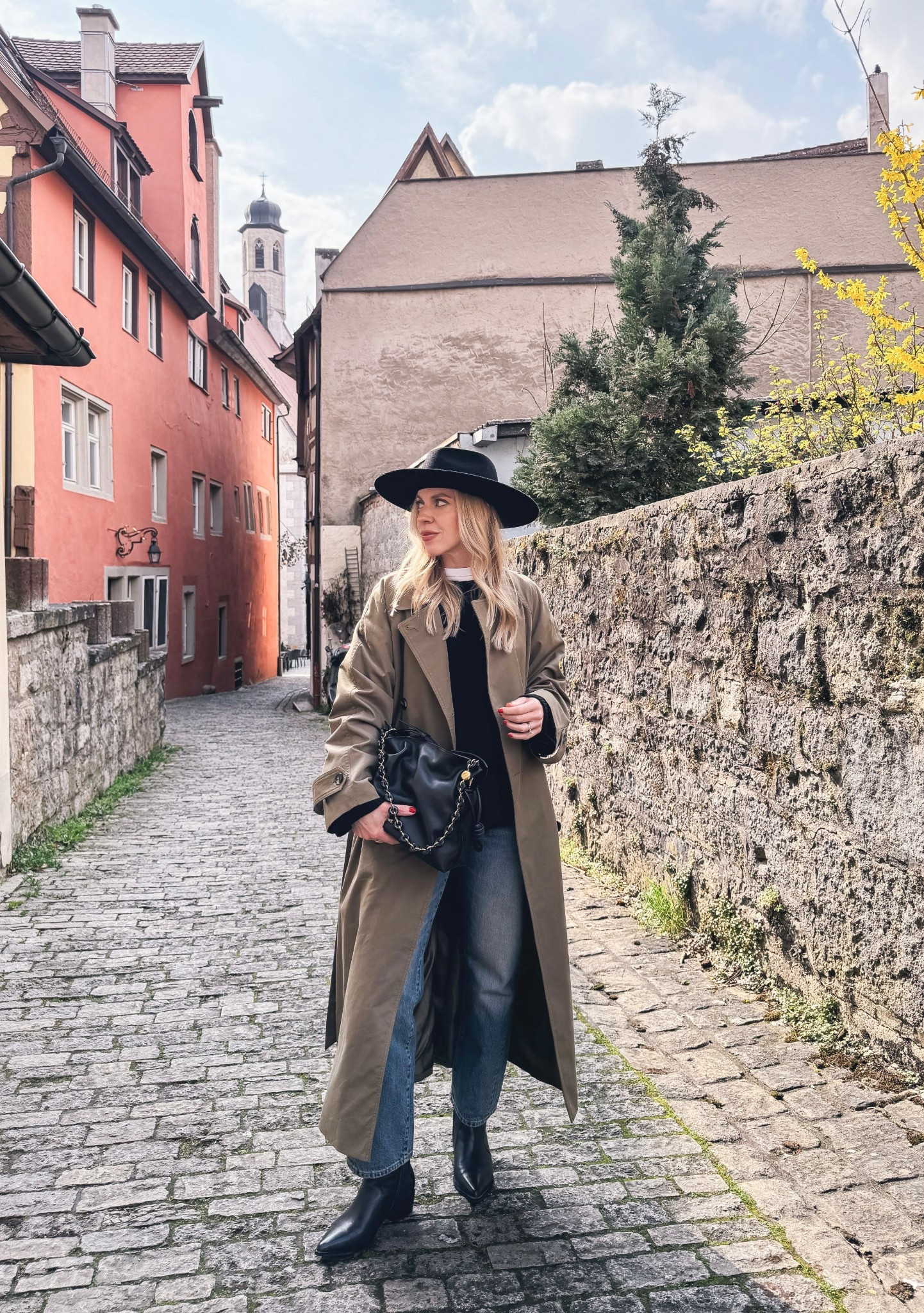 Spring travel look, olive green trench coat, cropped straight leg jeans, Loewe Flamenco pouch handbag 

#LTKOver40 #LTKSeasonal #LTKTravel