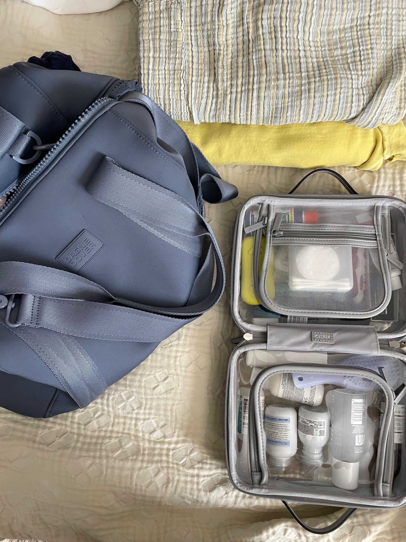 Packing for a weekend trip with 2 of my travel non-negotiables: 

1. This Dagne Dover weekender bag has been my carry-on for the last year and I couldn’t love it more. It packs a ton, and with 3 interior pockets, plus an additional zip pouch, it keeps me super organized.  And it’s machine washable!  

2. This CalPak toiletry case. It comes in 3 sizes, the medium in my opinion is just right. It lays flat, wipes clean, and fits a ton. 