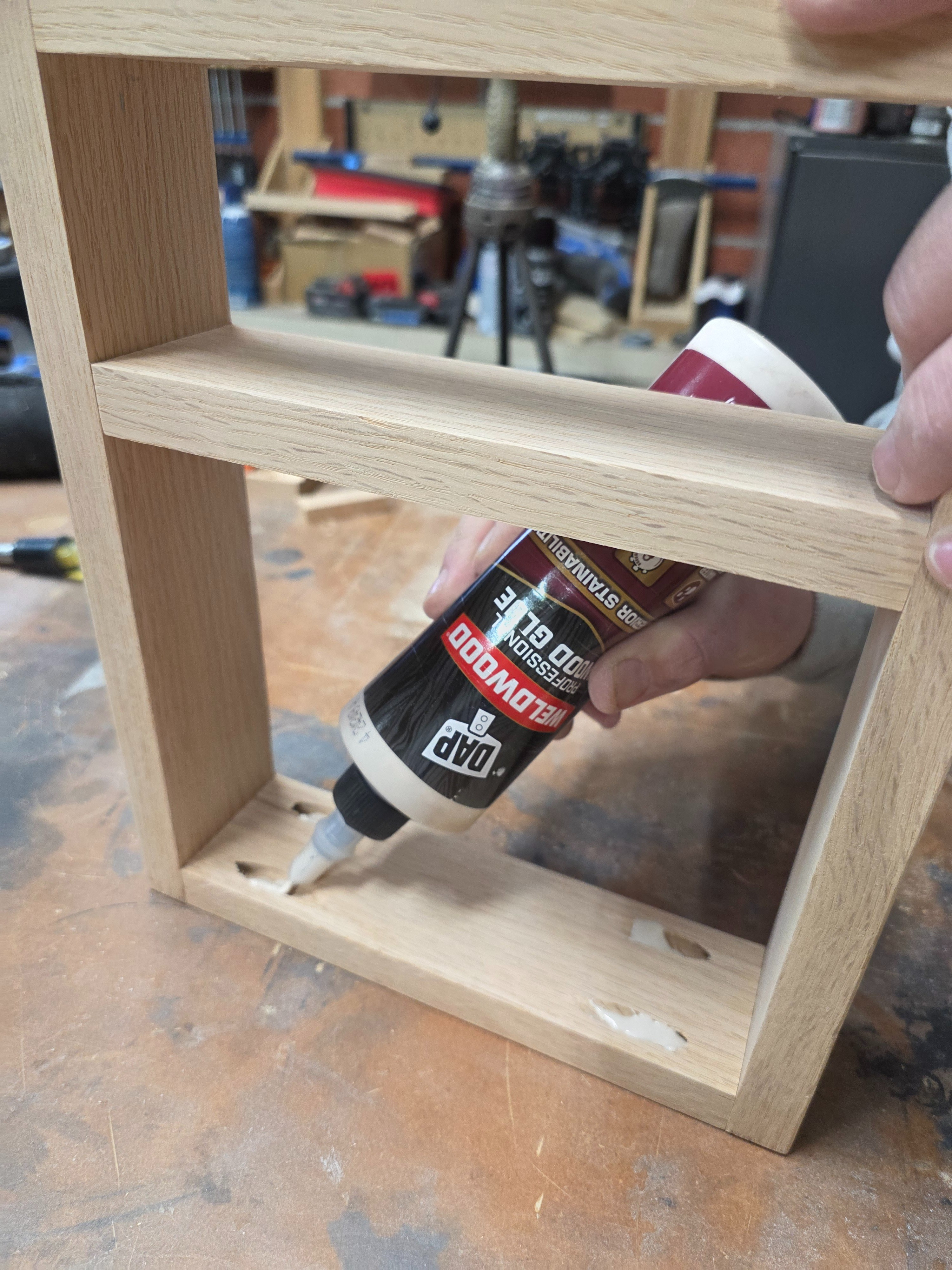 Time to glue in the pocket hole plugs. Start by filling the hole with wood glue, then push the plug in snug to the pocket hole and wipe off any excess glue. After it is all dried and you can smooth and fill any gaps with wood filler. #woodworking #pocketholes 

 