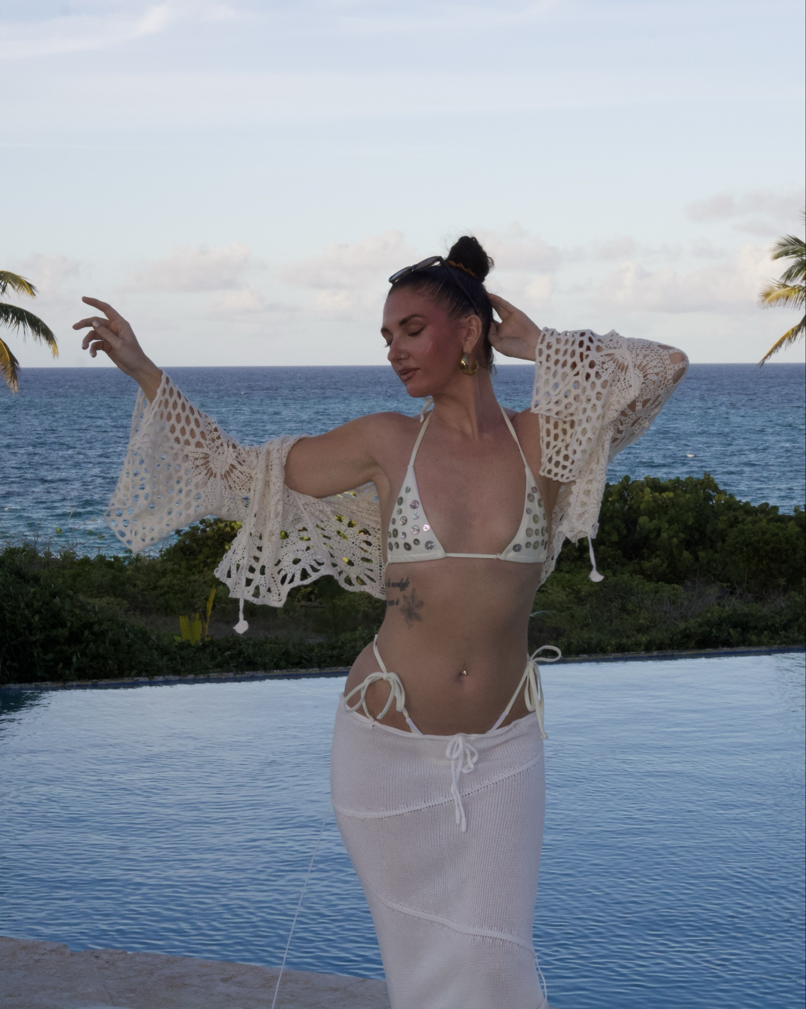 white crochet vacation outfit for beach dinner, tropical resort look with bikini top and sheer skirt, coastal summer style inspo for island trips 

this is what i pack when i want something that goes from poolside to dinner without thinking twice. lightweight, breathable, a little sheer, a little sculpted. perfect for a beach club, sunset drinks, or walking back salty from the ocean feeling like the moment never ended.

#vacationoutfits #beachoutfitideas #tropicalstyle #resortwear #islandoutfits #beachdinnerlook #crochetset #sheerskirt #summeroutfits2026 #honeymoonoutfits #poolsideoutfit #coastalstyle #bikinioutfit #vacationstyle #beachwear #islandstyle #traveloutfits #resortstyle #summerfashion 

#LTKootd #LTKTravel #LTKSwim