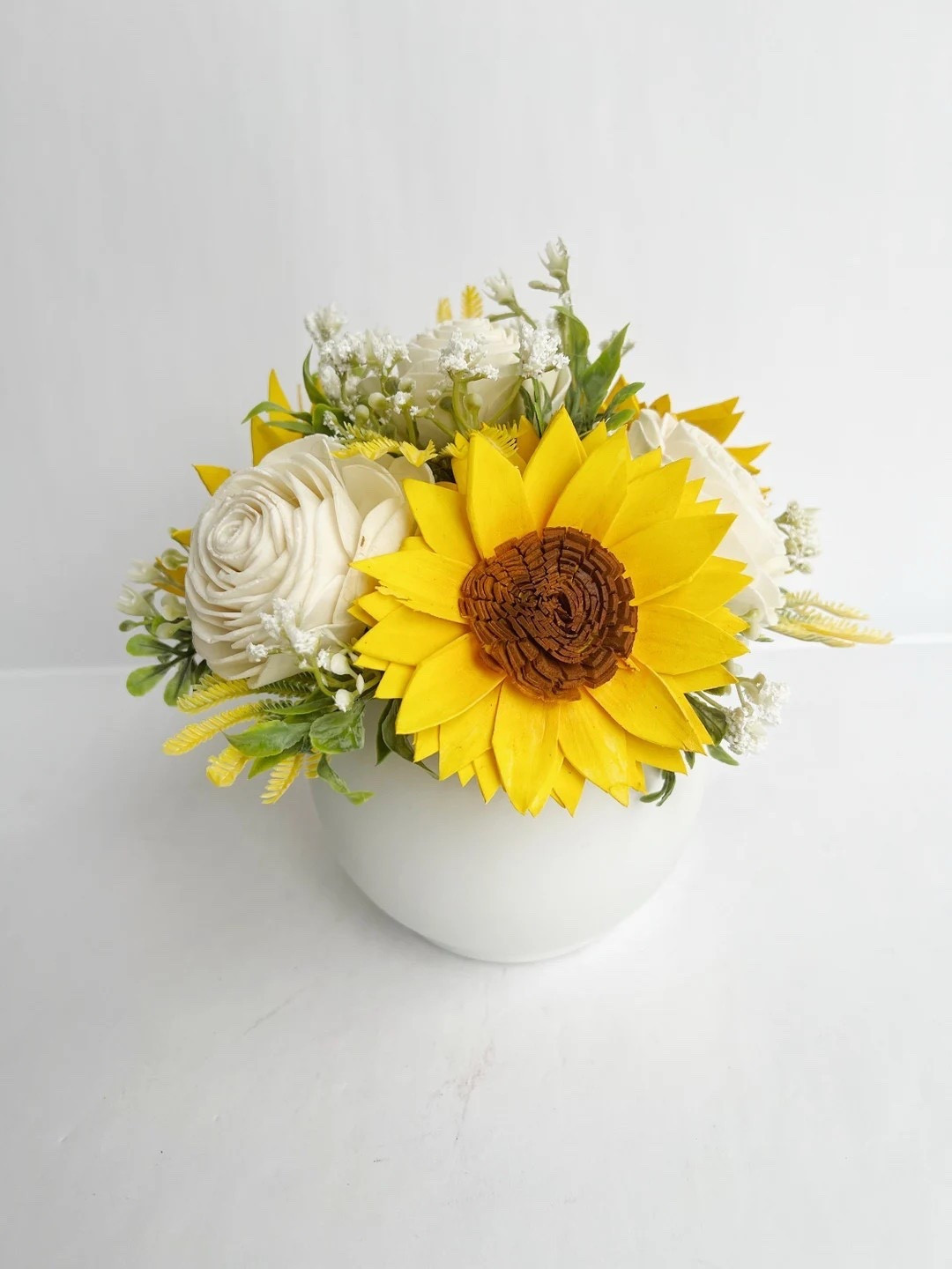 Brighten any space with this charming sunflower arrangement from WoodandRoseFlorals, designed with beautifully handcrafted sola wood flowers that last forever. Set in a classic white vase with soft greenery, this cheerful design adds warmth and sunshine to desks, shelves, or side tables. Perfect for birthdays, Mother’s Day, graduations, or just because, this eco-friendly arrangement brings lasting beauty without the need for watering or upkeep.

#LTKHome #SunflowerDecor #SolaWoodFlowers #ForeverFlowers #HomeDecorFinds #FarmhouseStyle #DeskDecor #GiftIdeas #SpringDecor #SummerDecor #FloralDecor #EcoFriendlyDecor #HomeInspo #LTKFinds 

#LTKHome #LTKdayinmylife #LTKSeasonal