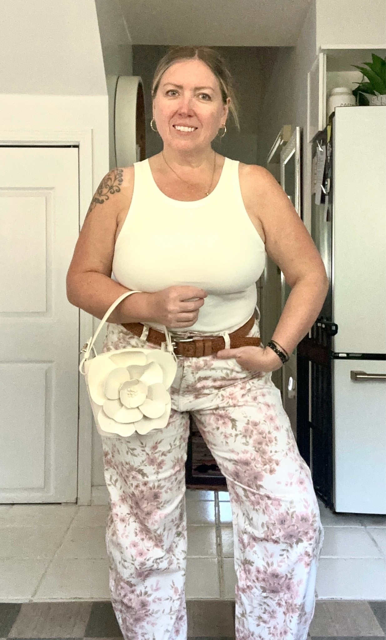 Vacation mode, but make it effortless. 🌴🤍
A crisp white fitted tank paired with statement floral barrel jeans and the cutest architectural 3-D tropical flower bucket bag. The light, neutral palette makes this the perfect look for a sunny getaway, exploring a new town, or an easy lunch date.
The bag is definitely the statement piece. 🌺👜
#LTKStyle #VacationOutfits #SummerStyle