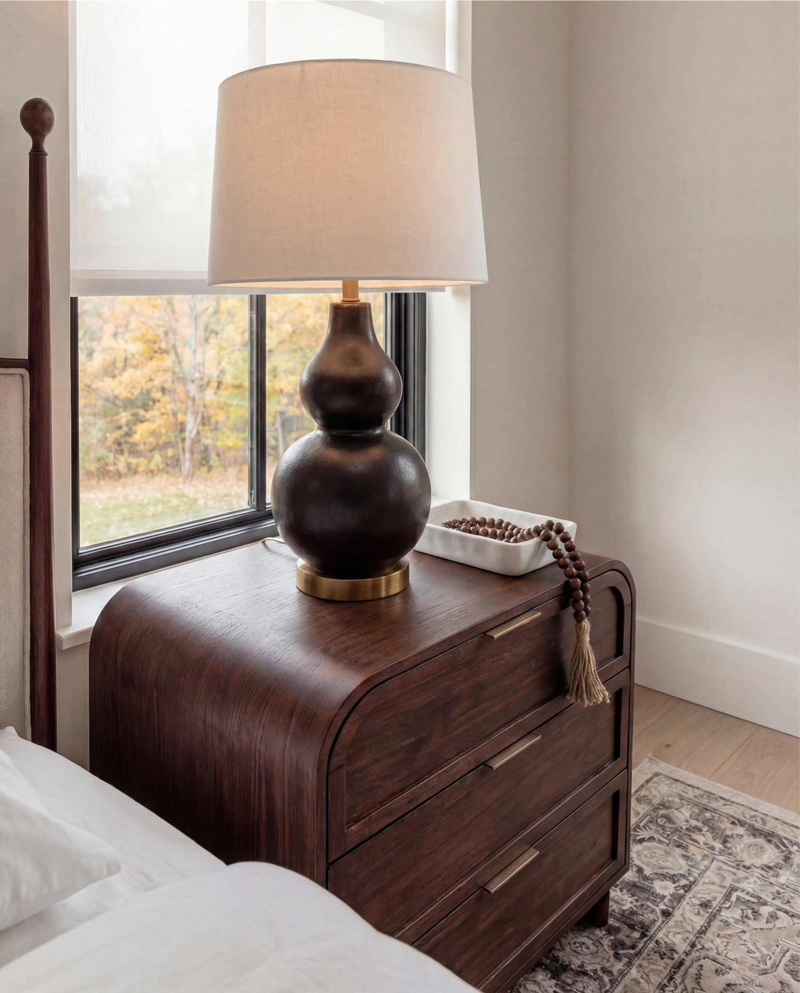 Furniture & Decor
	•	Upholstered wood bed frame (cream fabric)
	•	White bedding set
	•	Chunky knit throw (camel)
	•	Patterned accent pillows (rust/brown)
	•	Wood nightstands
	•	Ceramic table lamps (black base, white shade)
	•	Curved brass-framed wall mirror
	•	Framed floral wall art above bed
	•	Upholstered boucle bench stools (set of two)
	•	Vintage-style area rug (neutral pattern)
	•	Wood dresser with brass corner details
	•	Decorative ceramic vase
	•	Stacked neutral books
	•	Brass decorative tray
	•	Sculptural brass object
	•	Framed artwork above dresser
	•	Exposed wood ceiling beams

#LTKHome #LTKSaleAlert #LTKFindsUnder100