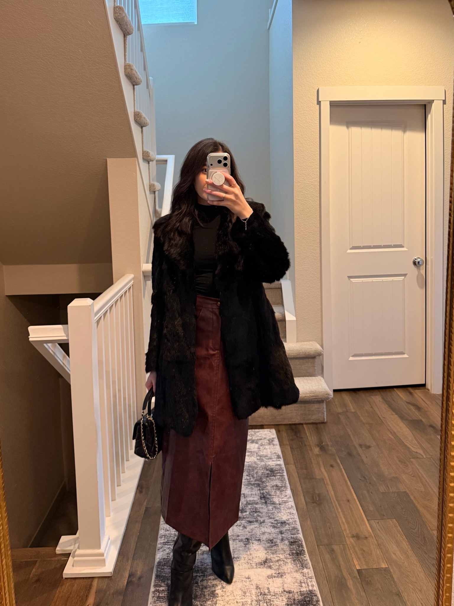 Leather midi skirt, black bodysuit, black boots, fur coat