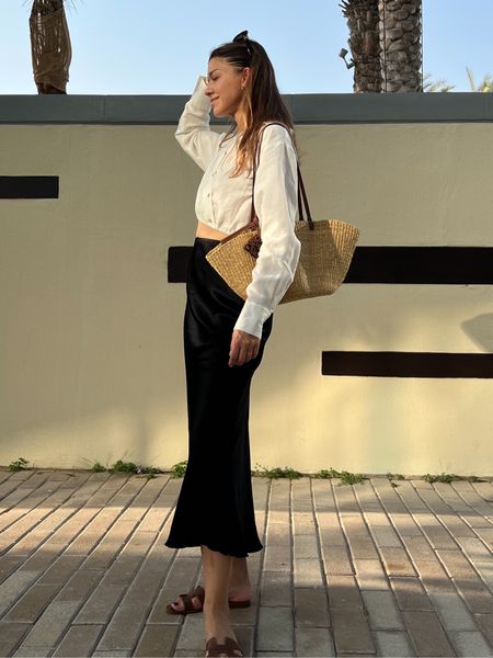 Black silk maxi skirt, cropped shirt, raffia bag, caramel trousers 

#LTKtravel #LTKSeasonal #LTKeurope