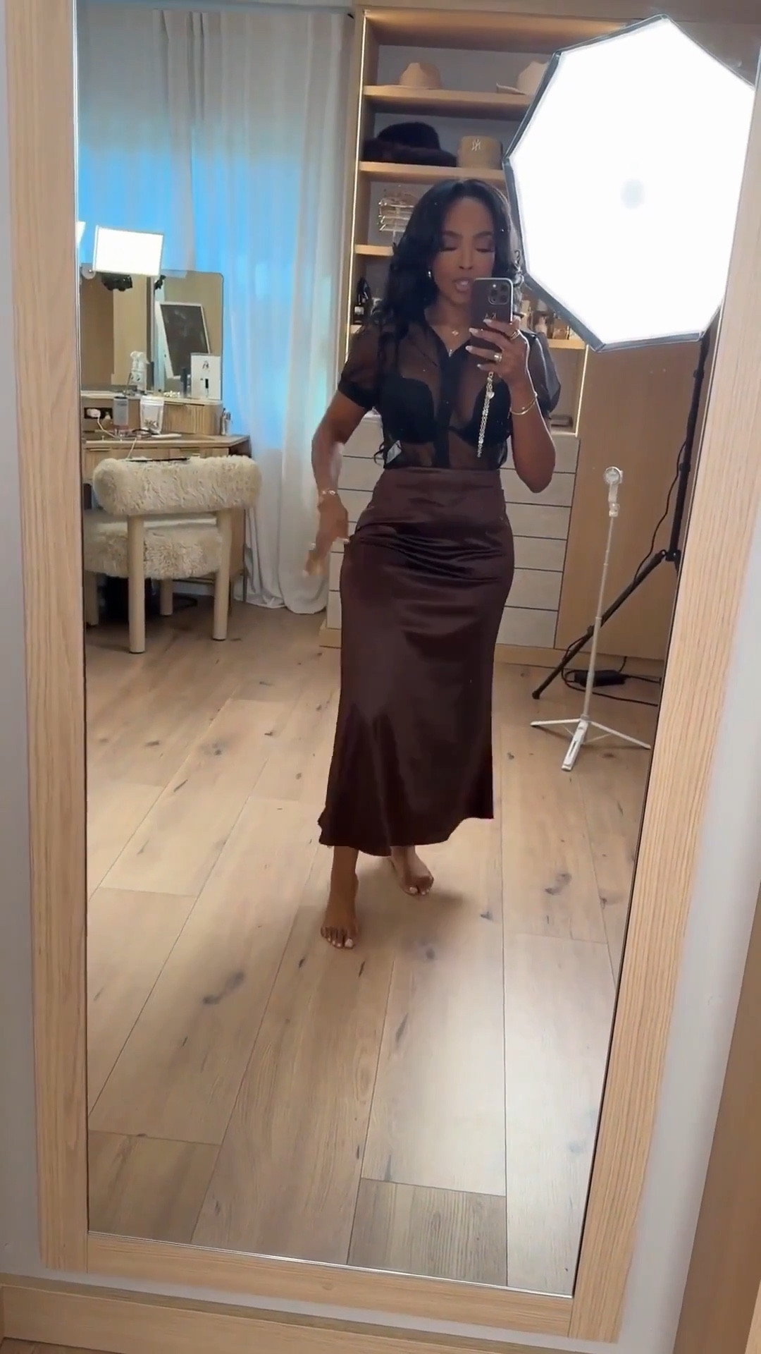 This satin skirt moment is pure elegance with an edge. The fluid drape paired with a sheer top gives that effortlessly dressed-up vibe that works for both nights out and elevated dinners.

One of those pieces that styles endlessly — swap the top, add a blazer, or dress it down with flats and the cost per wear keeps dropping. A true long-term closet staple.

Perfect for date nights, birthday dinners, cocktail events, girls’ night out, or vacation evenings.

📏 Sizing & Fit  
Top: Size Small  
Skirt: Size Small  

📐 Measurements  
Height: 5'4"  
Weight: 138 lbs  
Bust: 34D  
Waist: 27"  
Hips: 40"  

Save this post to revisit later or tap to get details.

satin midi skirt outfit, sheer top styling, elevated date night look, chic dinner outfit, luxury look for less, versatile evening wear

Follow me on Instagram and YouTube @kirasfashionfinds