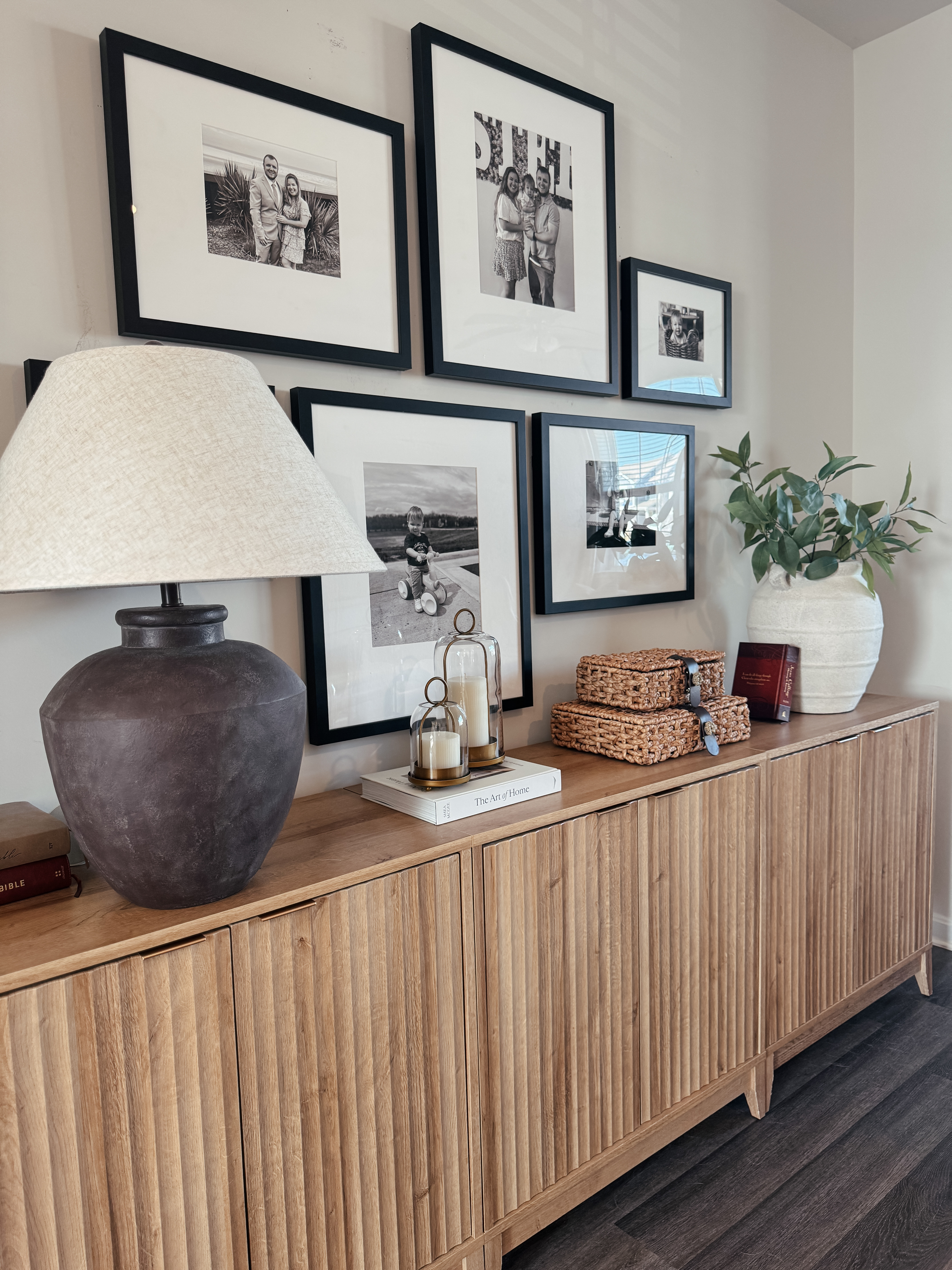 Cozy console table styling 🤎

I love decorating with pieces that look beautiful but are also functional for our home. This fluted wood console cabinet is one of my favorite pieces because we actually store toys inside the cabinets, which helps keep the living space looking calm and clutter-free.

I styled the top with a family photo gallery wall, brass candle holders, stackable woven baskets, and neutral decor to keep the space feeling warm and personal. The woven baskets are an Amazon find and such a good McGee & Co look for less, and they add the perfect natural texture.

Everything is linked in my LTK if you’re looking for console table styling ideas, gallery wall inspiration, McGee & Co dupes, Amazon woven baskets, fluted console cabinets, or modern organic home decor.

#consoletabledecor #gallerywall #mcgeeandcodupe #amazonhomefinds #wovenbaskets #modernorganicdecor #neutralhome #entrywaydecor #homedecorideas #ltkhome #affordablehomefinds #consoletablestyling #cozyhome #neutraldecor

#LTKHome #LTKSaleAlert #LTKOver40