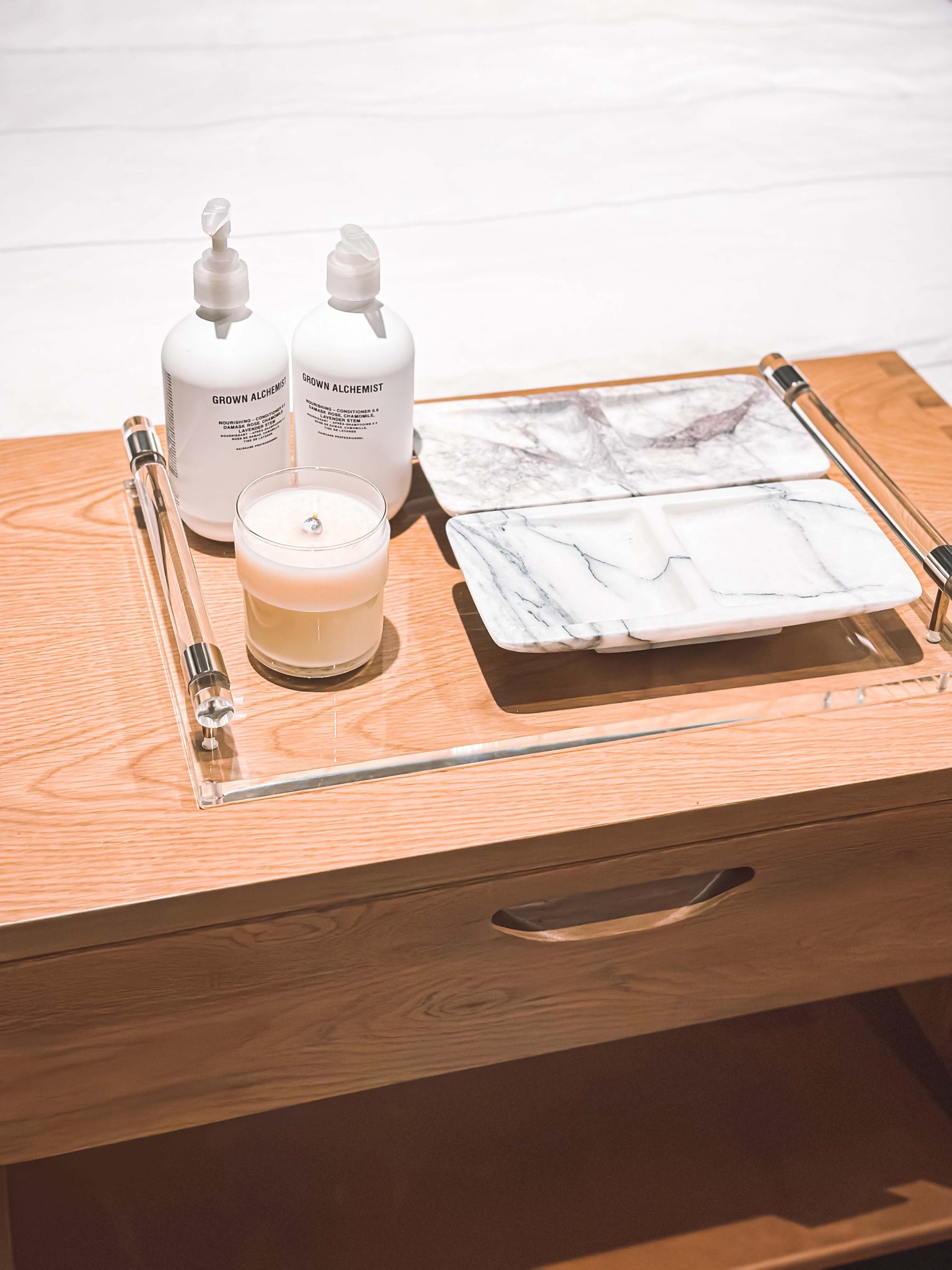 APOTHIA IF SOY WAX CANDLE, GROWN ALCHEMIST NOURISHING SHAMPOO, DAILY ESSENTIALS MARBLE JEWELRY TRAY, THERON ACRYLIC TRAY..
