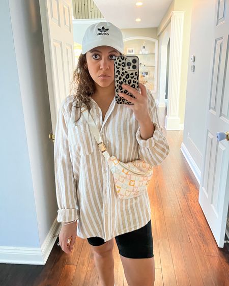 A second way to wear this striped breezy button up top. Paired it with biker shorts, a fanny pack and a baseball cap for an athleisure look ✔️ 

Travel look. Spring transition look. Vacation look. Vacation outfit. Target style. Fanny pack. Disney outfit. Biker shorts. 

#LTKMostLoved #LTKtravel #LTKstyletip