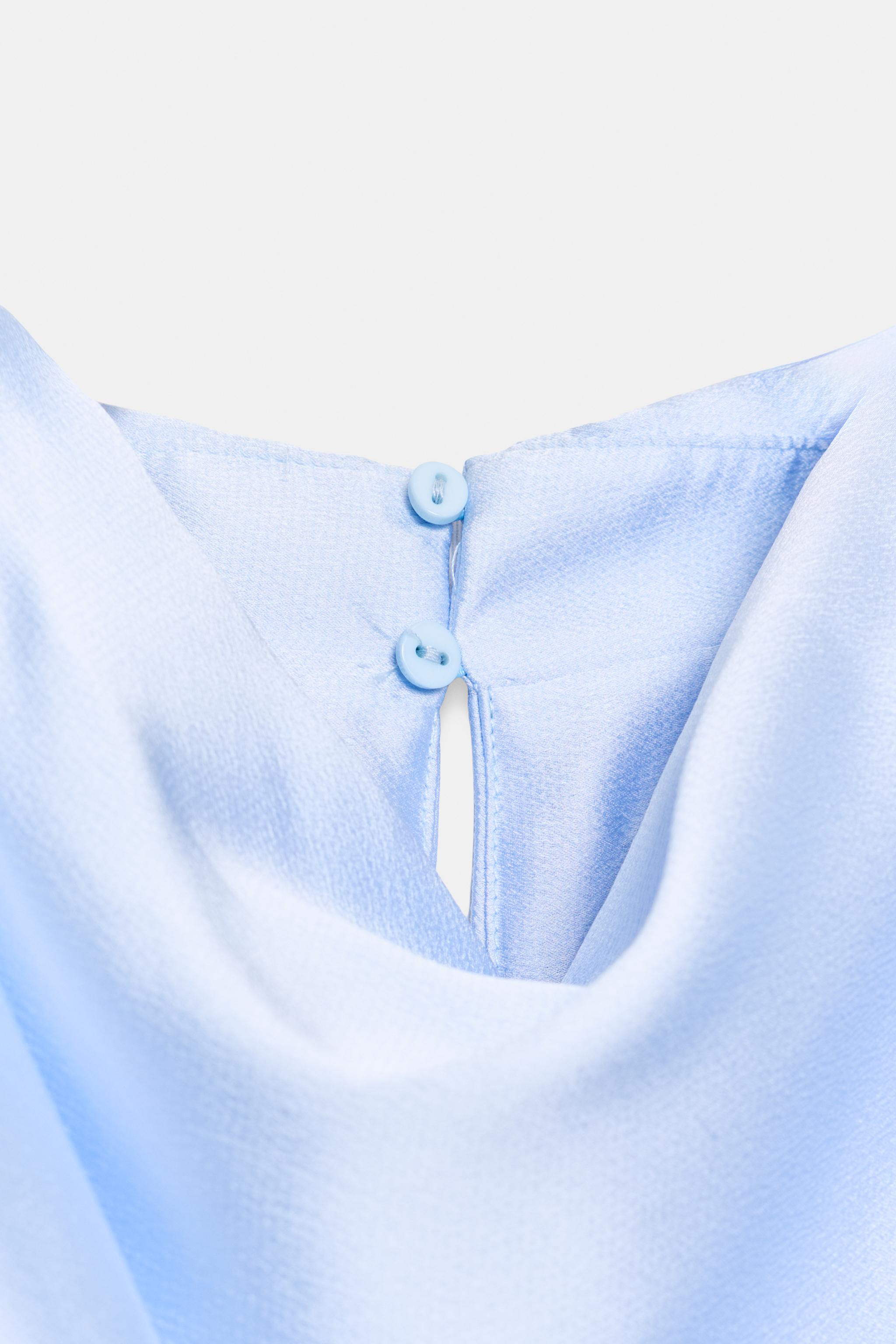 High-neck, sleeveless top featuring shoulder pads and pleats. Knotted hem. Back opening with hidd... | Zara US