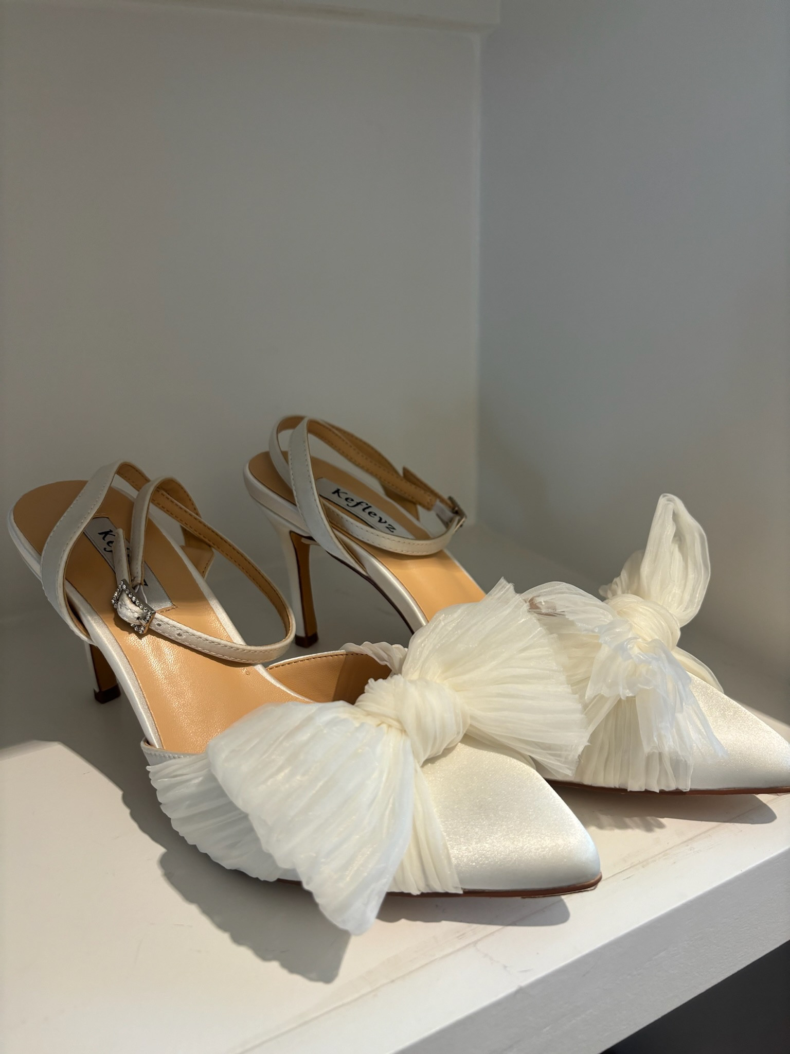Bow knot wedding shoes! 

Pointed toe, ankle strap, bridal, high heels, big bow