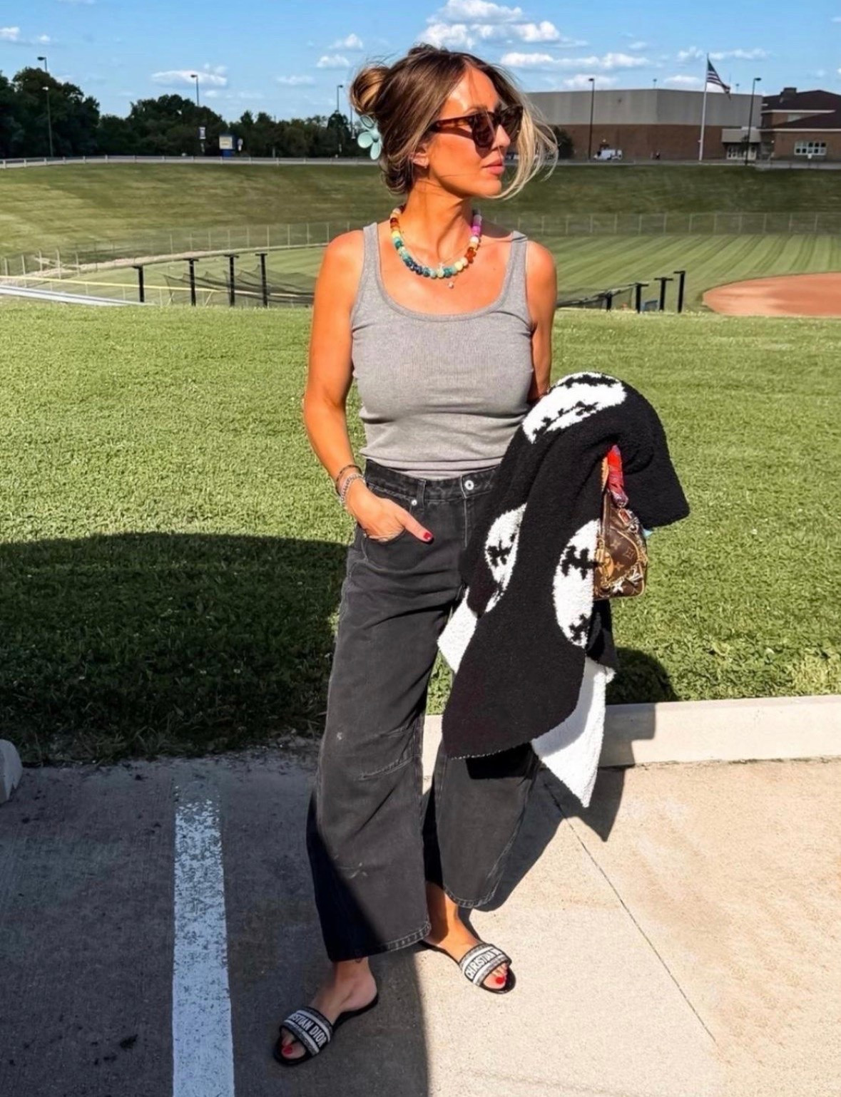 This casual game day outfit is the perfect mix of comfortable and elevated. The gray tank keeps it simple, while the relaxed black denim and colorful beaded necklace add personality. I love the lightweight sweater layered over the shoulders for when the temperature drops later.

game day outfit, casual outfit, black jeans, gray tank top, beaded necklace, layered outfit, weekend style, elevated casual, summer outfit, everyday fashion, TheMomInStyle

#LTKootd #LTKSeasonal #LTKOver40