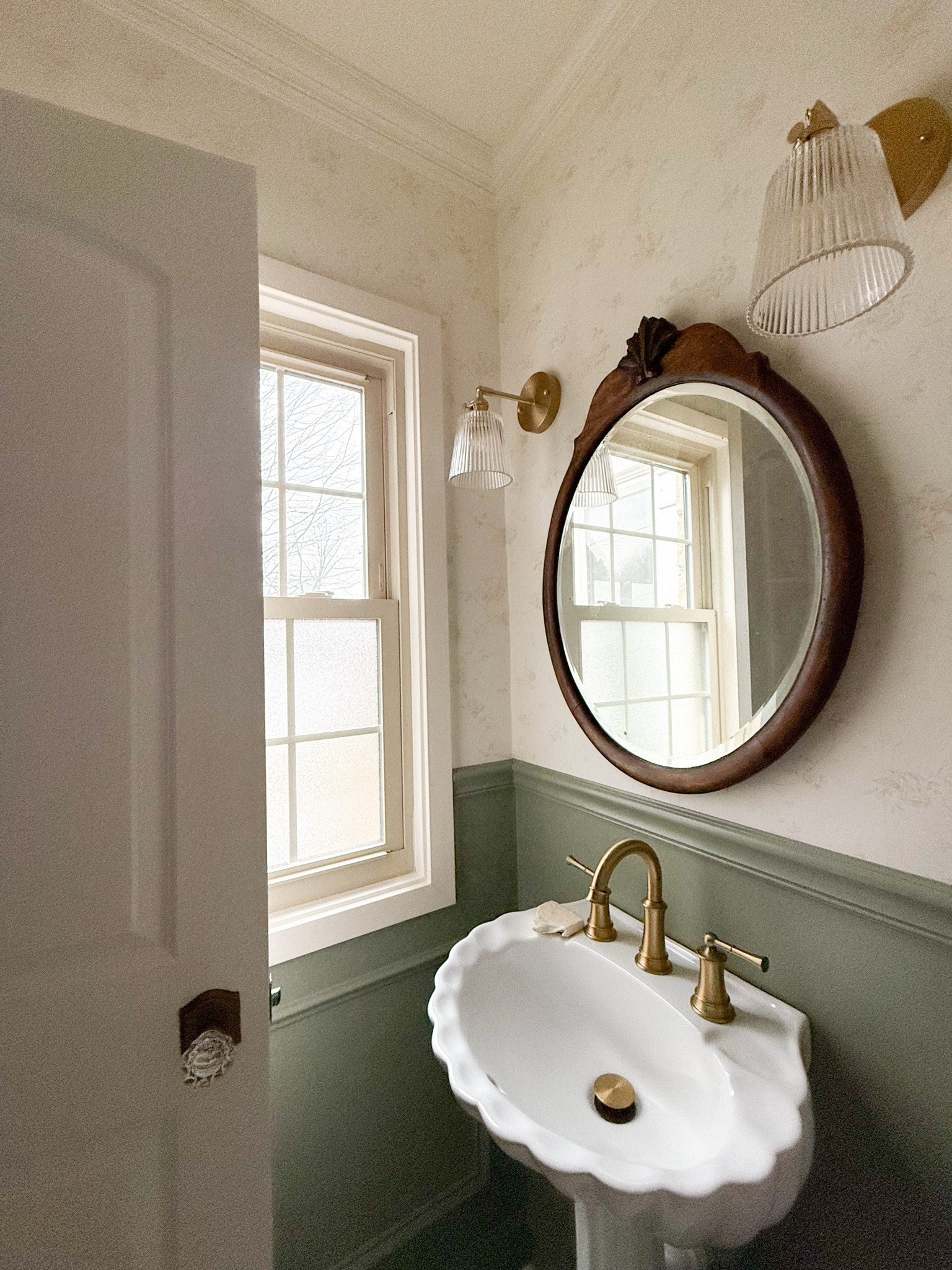DIY half bathroom, traditional with a modern twist. Pedestal sink, thrifted antique mirror, brass and glass accents. Paint colors: SW Creamy, SW Evergreen Fog. 

#LTKFindsUnder100 #LTKHome