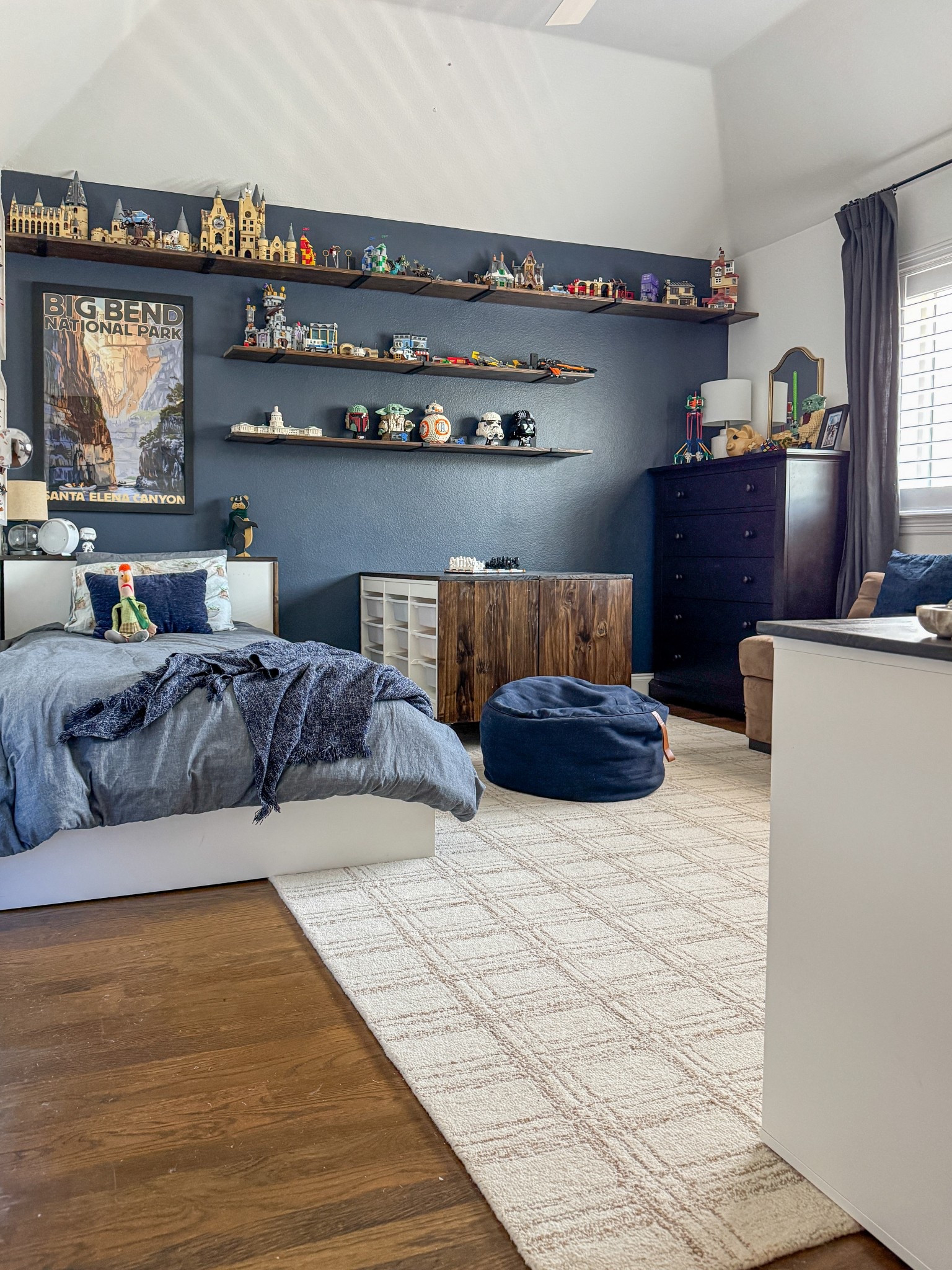 Affordable cozy teen boy bedroom, Lego collection display, dark accent wall, wood floors, neutral rug, organized storage, transitional style

#LTKHome #LTKKids