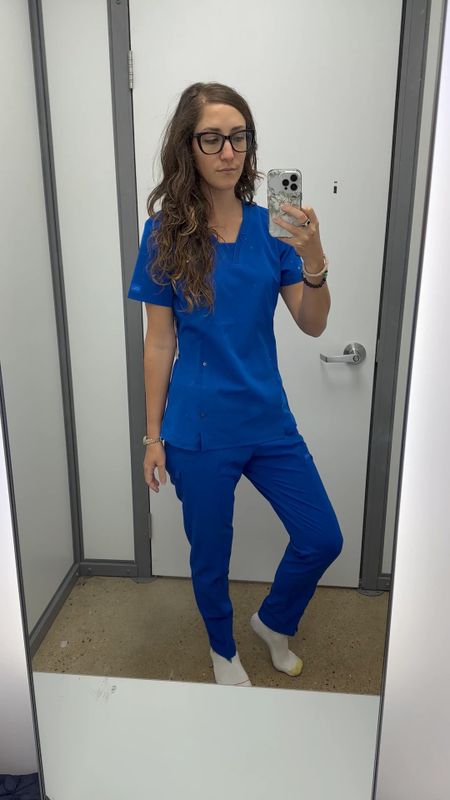 Finally buying myself some legit scrubs! 💙 I tried on all the brands we carry at Walmart and these Dickies scrubs came out on top! They have a thicker material than the Scrub Star ones which were my second favorite option. I love the edgy grommet details against the flattering silhouette, and the high rise pants with elastic waistband are so comfy! I am usually between and small 4-6 top and medium 8-10 bottoms, the small top and small pants fit me perfectly with no need to size up here! I got them in black too 🖤

#LTKfit #LTKunder50 #LTKworkwear