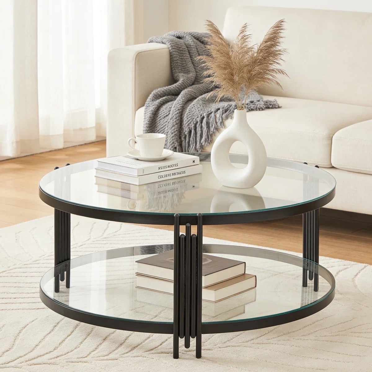 This modern round glass coffee table combines sleek transparency with a bold black metal frame and functional two-tier storage, creating a sophisticated centerpiece for elevated contemporary living rooms ✨ ON SALE and under $200.

Keywords:

* modern glass coffee table
* round coffee table
* black metal coffee table
* 2 tier coffee table
* glass center table
* contemporary living room furniture
* modern center table
* open storage coffee table
* modern luxury interiors
* minimalist living room decor
* boutique hotel aesthetic
* architectural furniture design
* curated contemporary home
* sleek modern furniture
* elevated living room styling
* airy interior decor

#LTKSeasonal #LTKHome #LTKSaleAlert