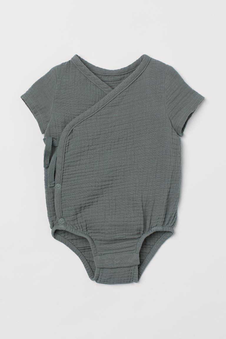 Baby Exclusive. Short-sleeved bodysuit in woven organic cotton fabric with ties at one side. Snap... | H&M (US + CA)