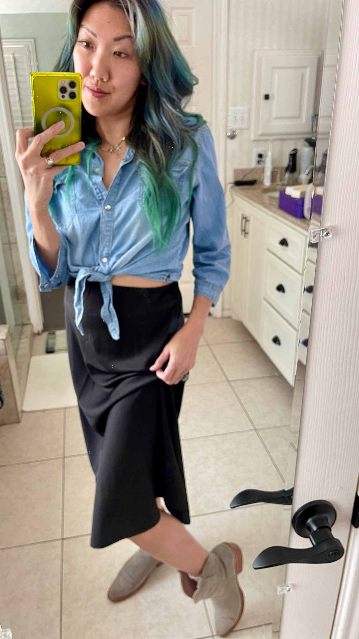 Women’s denim shirt, cropped tie up fit, pearl snap button up top. Black silky satin skirt paired with neutral colored ankle boots fit for summer 2024 into the fall season. Staple jewelry investment piece- gold paperclip necklace 

Here’s a style tip- tie up your satin skirt from the inside to give it a new look! I like it ruched on one side to show off footwear. Dress it up with western accessories for a country concert outfit, denim cut off shorts for a festival, or just wear it out casually to the grocery storee

#LTKStyleTip #LTKShoeCrush #LTKFindsUnder50