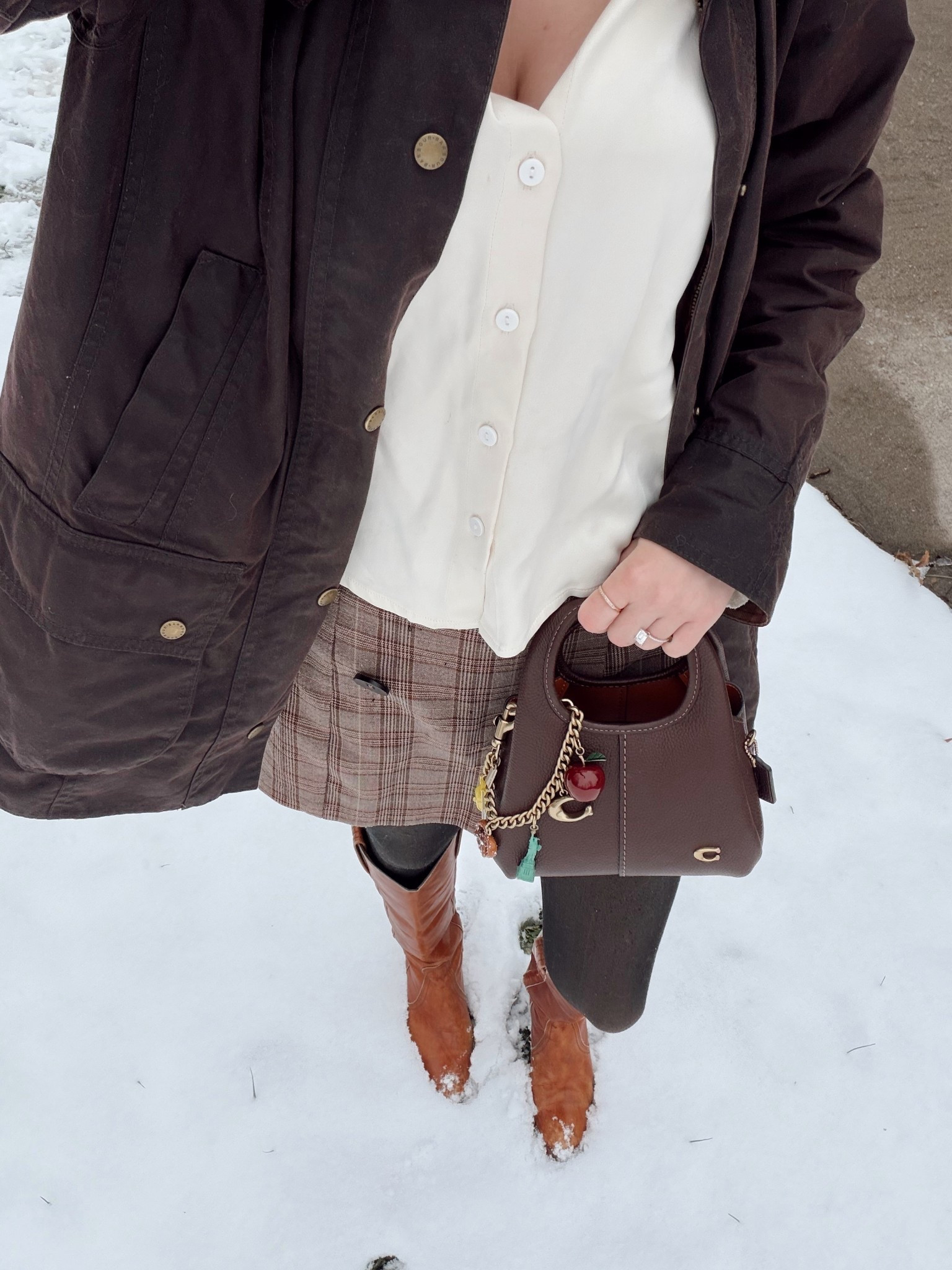 Snow day OOTD ❄️

Coach Lana 19
Coach NYC bag charm chain
Barbour wax jacket

Similar plaid skirt/skort
Frye boots 