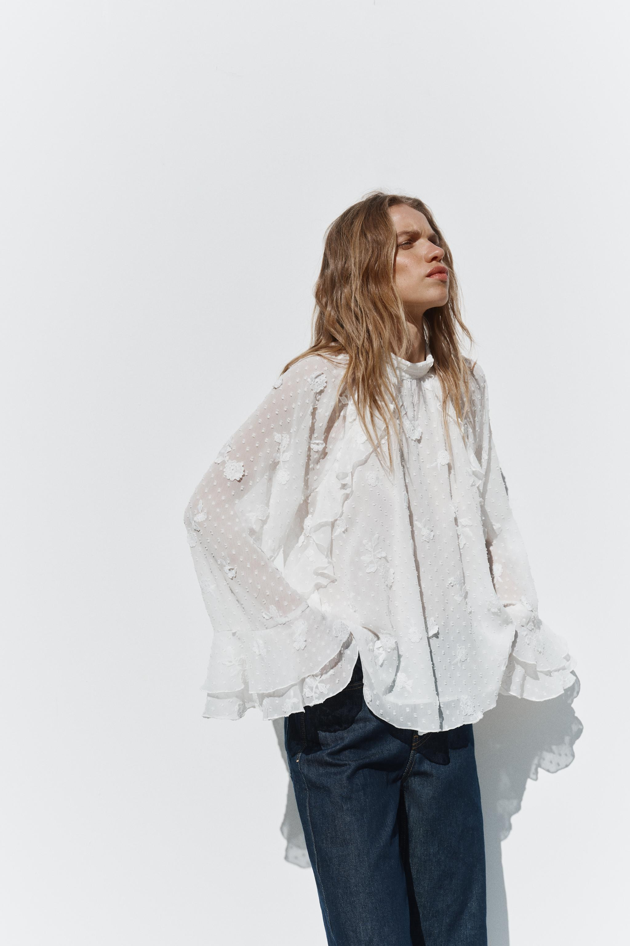 High neck shirt with wide sleeves. Featuring raised embroidered flowers and ruffle trims. Conceal... | Zara UK
