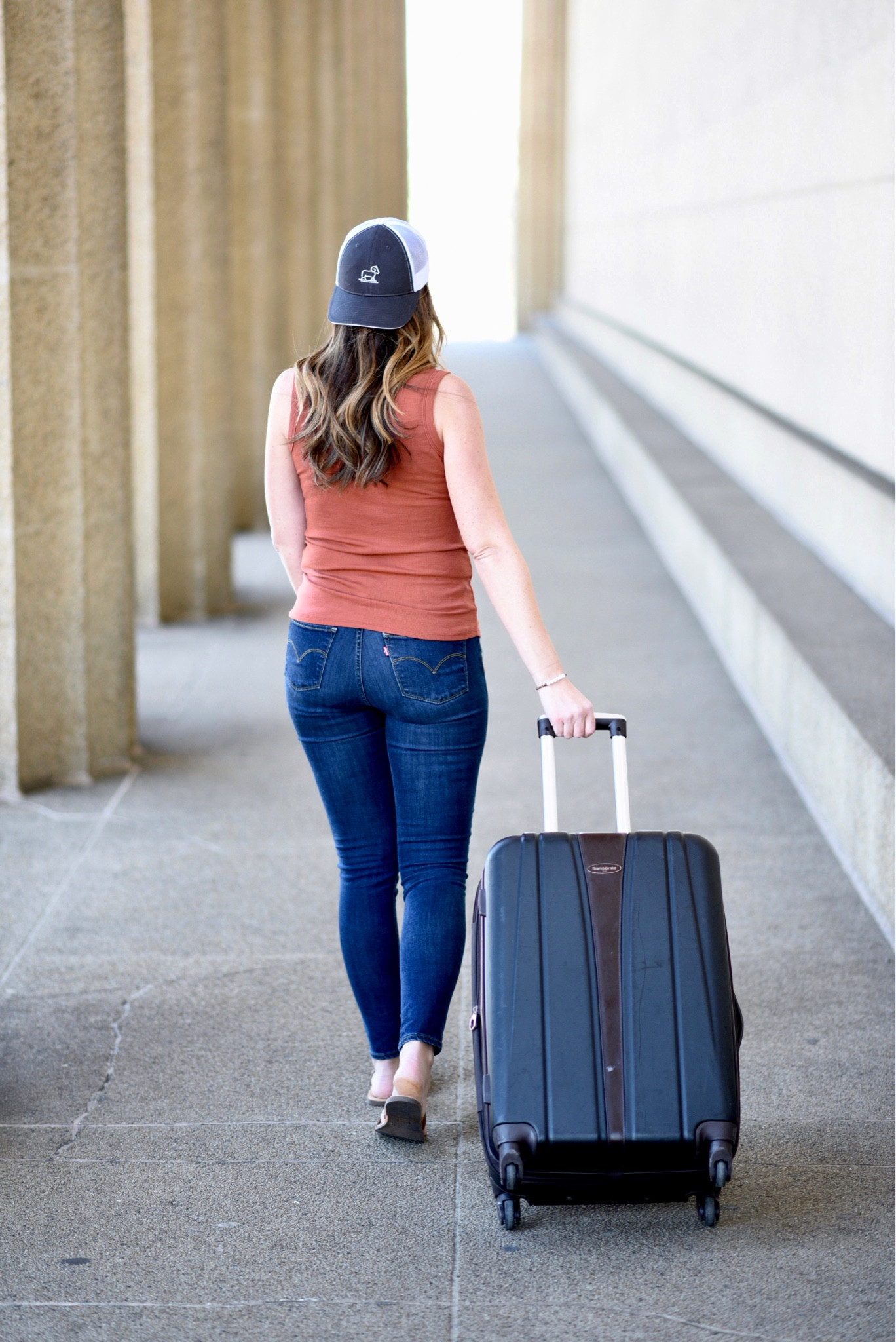 Travel outfit denim jeans Levi’s wide shoulder scoop Neck tank top trucker hat woolx merino wool leather camel slide sandals designer dupe look for less Walmart find Nashville outfits travel hardside spinner suitcase luggage

#LTKtravel #LTKFind #LTKfit