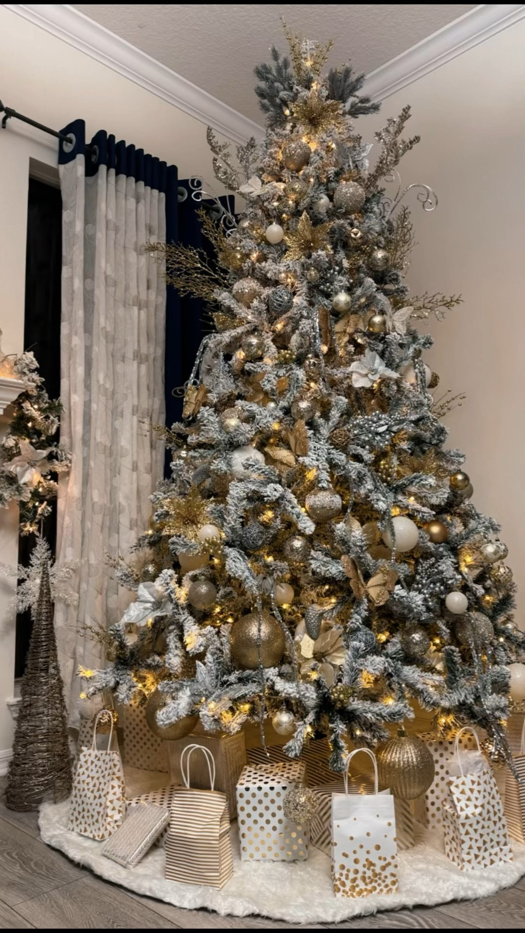 9 feel pre lit flocked Christmas tree with white and gold decor 