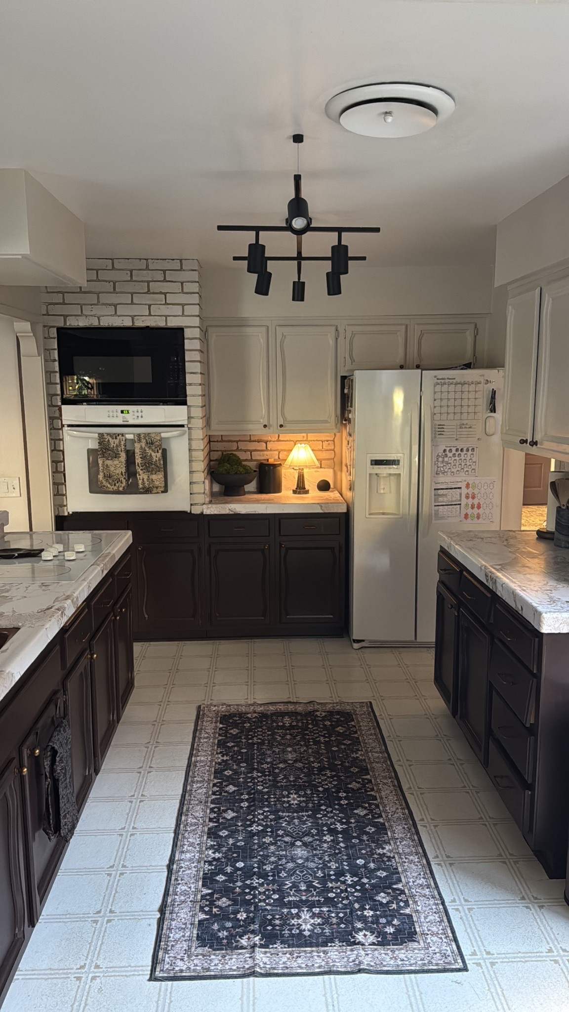 I have a very old kitchen that needs to be completely remodeled, but we can’t do it quite yet. I was very tired of looking at it, so I decided to fix it up a bit. I was hesitant to put any money into something temporary, but I’m so glad I did! We have yellow tile countertops, so I decided to use vinyl wrap to cover them. I’m a perfectionist, and this job broke me. It’s a lot harder than I thought, and I didn’t do a very good job. They still look better, even with all of the wrinkles. If you have a flat surface to cover, it would likely be easier. I like how thick the vinyl is, and it helped to use a heat gun to remove wrinkles. I also linked the hardware and rug I chose. Lamp is from Homegoods. 

#LTKFindsUnder100 #LTKHome #LTKFindsUnder50