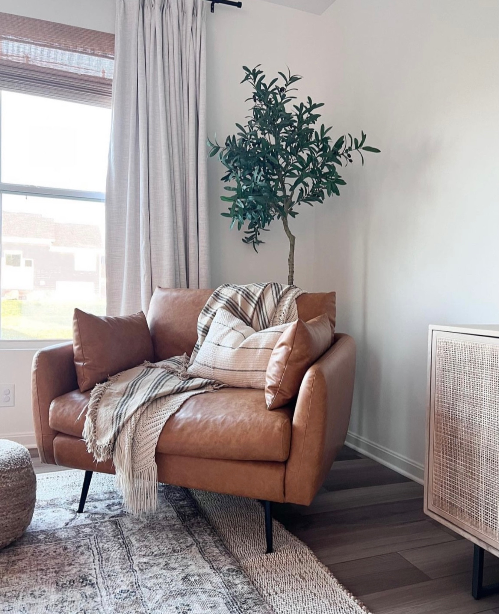 Shop my favorite corner in my home ✨ 

Faux leather accent chair, olive tree, throw pillow, target finds, jute rug, loloi rug, woven pouf, sideboard, throw blanket, curtain rods, pinch pleat curtains, bamboo shades 

#LTKFind #LTKhome #LTKstyletip