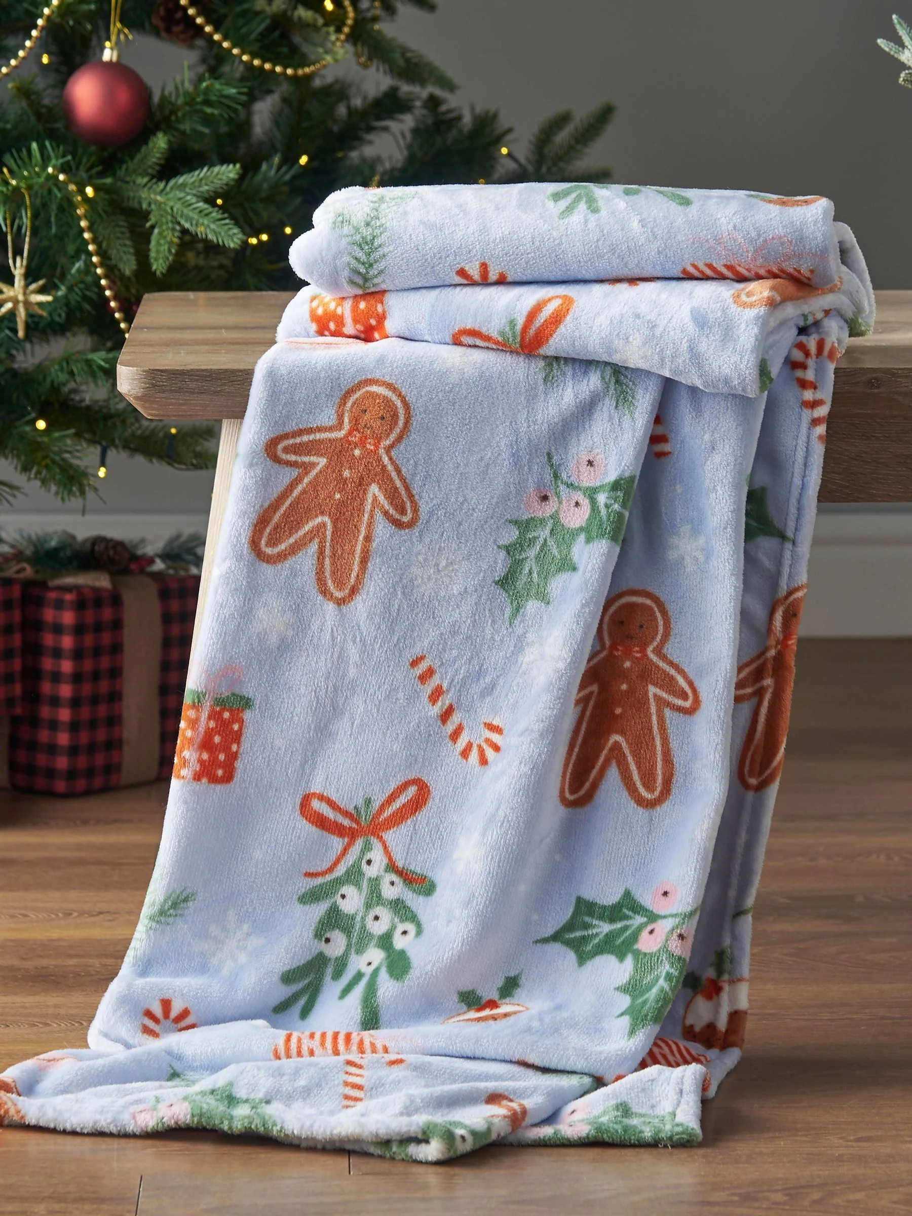Catherine Lansfield Catherine Lansfield Blue Christmas Gingerbread Soft and Cosy Fleece Throw | Next US