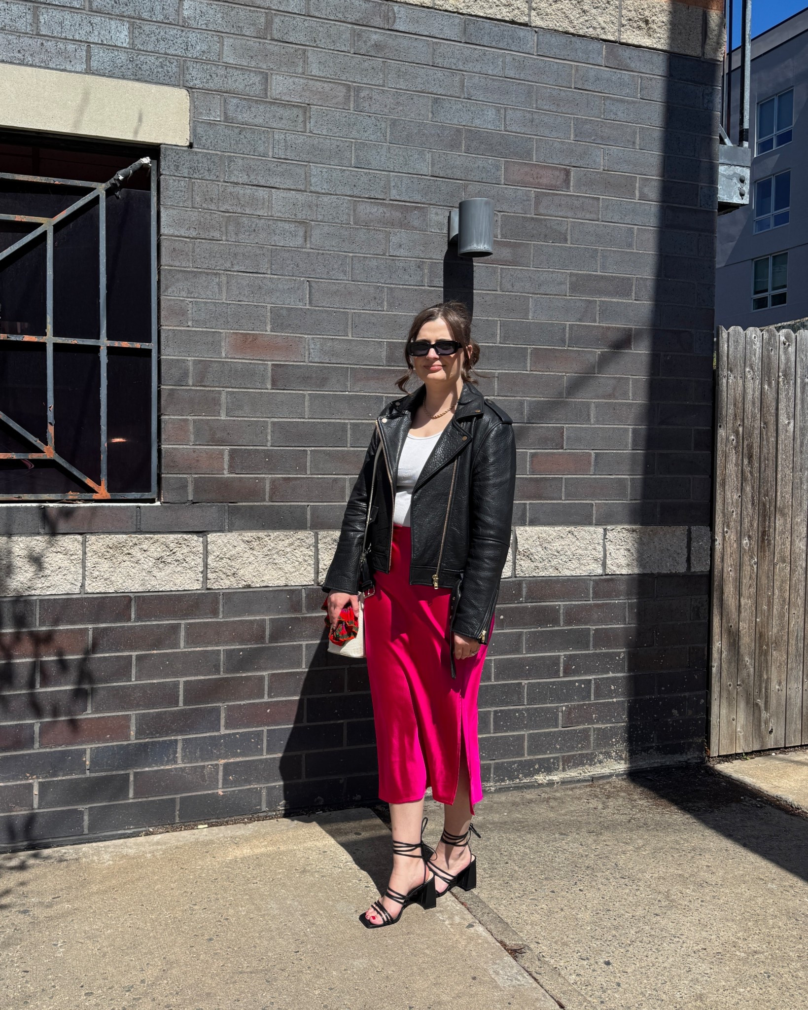 Spring Outfit ideas! A bold and modern ensemble that combines a black leather jacket with a vibrant pink midi skirt for a striking contrast. Styled with black strappy sandals and sunglasses, this outfit is a go-to for a polished yet edgy spring vibe.

#LTKFindsUnder100 #LTKStyleTip #LTKSeasonal