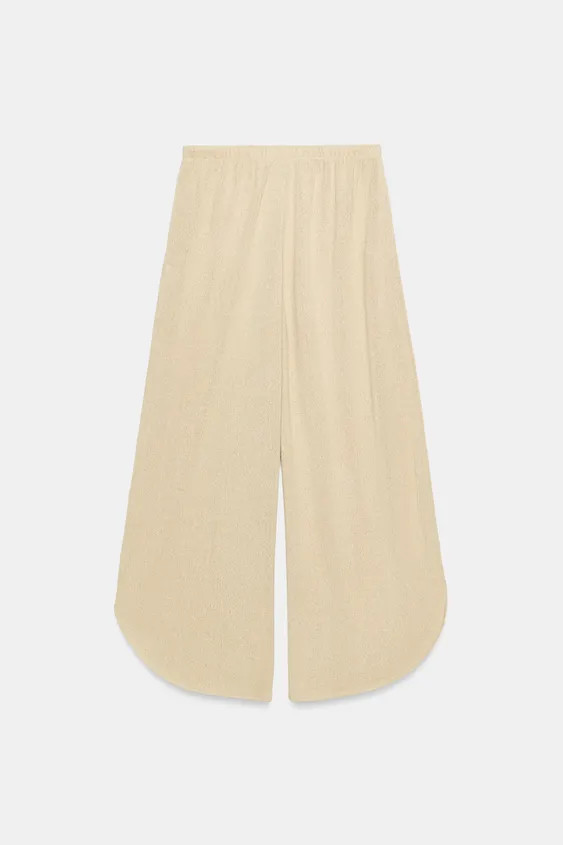 Pants made of rustic fabric. High-waisted with an elastic waistband. Wide-leg design with side ve... | Zara US