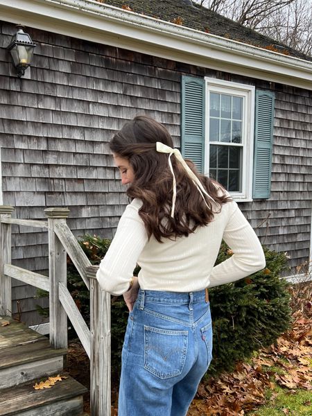 Fall casual style with thin white sweater, high waisted jeans, and hair bow 

#LTKHoliday