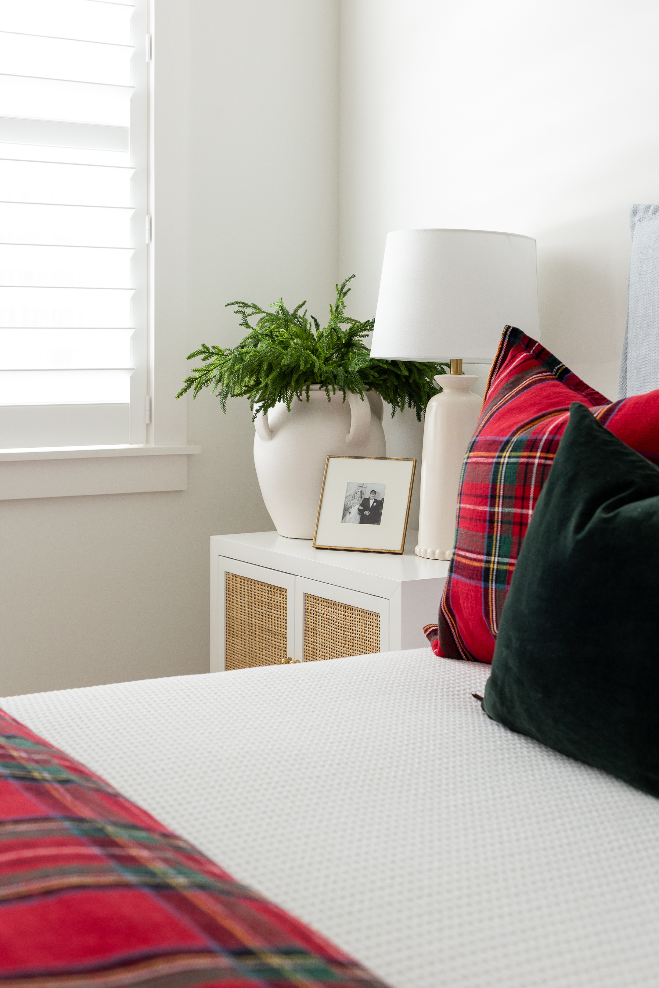 Our Norfolk pine look for less stems styled (I used all 12 here) in a white ceramic vase (size large) in our Christmas bedroom. They greenery looks so pretty paired with our red Stewart plaid bedding, dark green velvet pillows, light blue linen bed (I'll also link a look for less option), rattan nightstands, and ceramic lamp. See more Christmas greenery and stems options here: https://lifeonvirginiastreet.com/christmas-greenery-stems/ #ltkholiday #ltkhome #ltksalealert #ltkfindsunder50 #ltkfindsunder100 #ltkstyletip #ltkseasonal 

 #LTKHoliday #LTKHome #LTKFindsUnder50