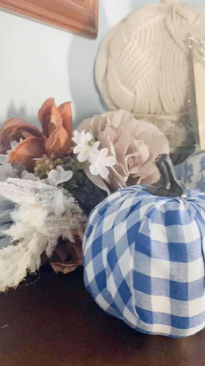 A little fall moment on my sideboard that makes me smile every time I walk by

This vignette brings together everything I love about the season — texture, nostalgia, and soft autumn color. The blue and white pumpkins tie the scene together: one in a traditional toile pattern and another in a playful gingham that keeps it casual and cozy. Nestled beside them, a faded blush rose and a few rust and ivory florals soften the look, blending that cottage feel with a hint of romance.

I added a bit of vintage personality with a sepia portrait wrapped in old paper, tucked behind the pumpkins and decorated with sparkling brooches for a touch of whimsy. It’s an unexpected detail that catches the light and feels like a quiet nod to the past.

This mix of blue and white ceramics, neutral blooms, and warm metallics is an easy way to transition from early fall into Thanksgiving — proof that cozy doesn’t have to mean orange and brown. It’s elegant yet homey, just the way I like it.

💡 Designer tip: Layer your fall decor the way you’d layer an outfit. Combine a pattern (gingham or toile), a soft texture (faux florals), and something vintage or shiny for personality.

Save this idea for your entry table, mantel, or kitchen corner — small spaces deserve seasonal charm too.

Follow @julie_ann_rachelle for more ways to blend blue-and-white classics with autumn warmth all through October and November.

#falldecor #thanksgivingdecor #blueandwhite #cozyhome #autumndecor #harveststyle #traditionalhome #cottagestyle #manteldecor #falldesignideas #LTKHome #LTKHoliday #LTKStyleTip 

 #LTKHoliday #LTKSeasonal #LTKHome