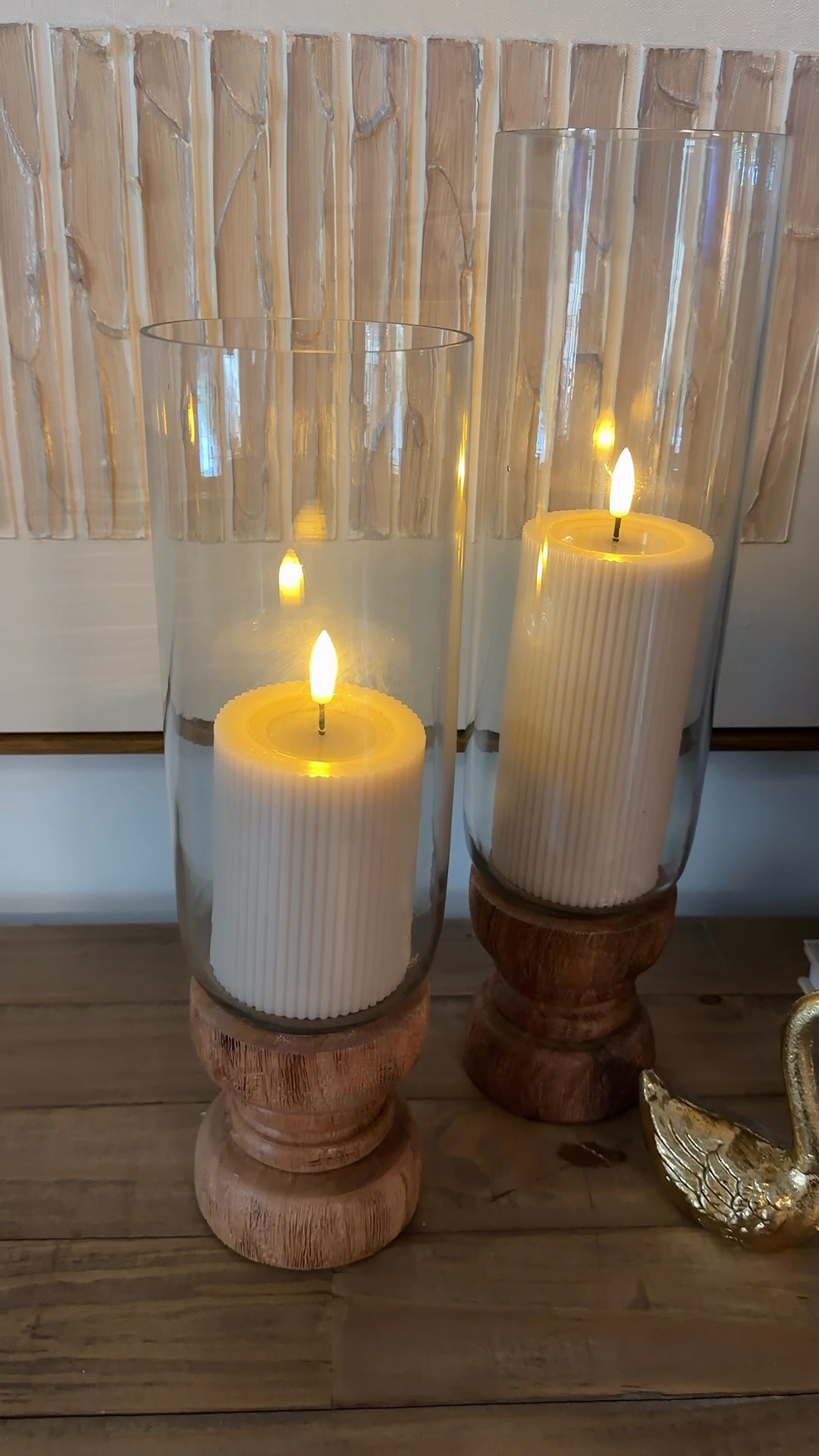 These hurricane candle holders are such a timeless styling piece. Available in two sizes, they feature a natural wood base with a clear glass hurricane cover for that soft, cozy glow we all love.

Style them alone or as a pair on your entryway table, dining table, or mantel for instant height, texture, and effortless charm.