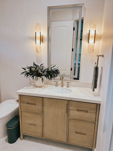 Loving our guest bathroom remodel. The warm wood and white walls create a clean serene balance for our guests 

#LTKHome