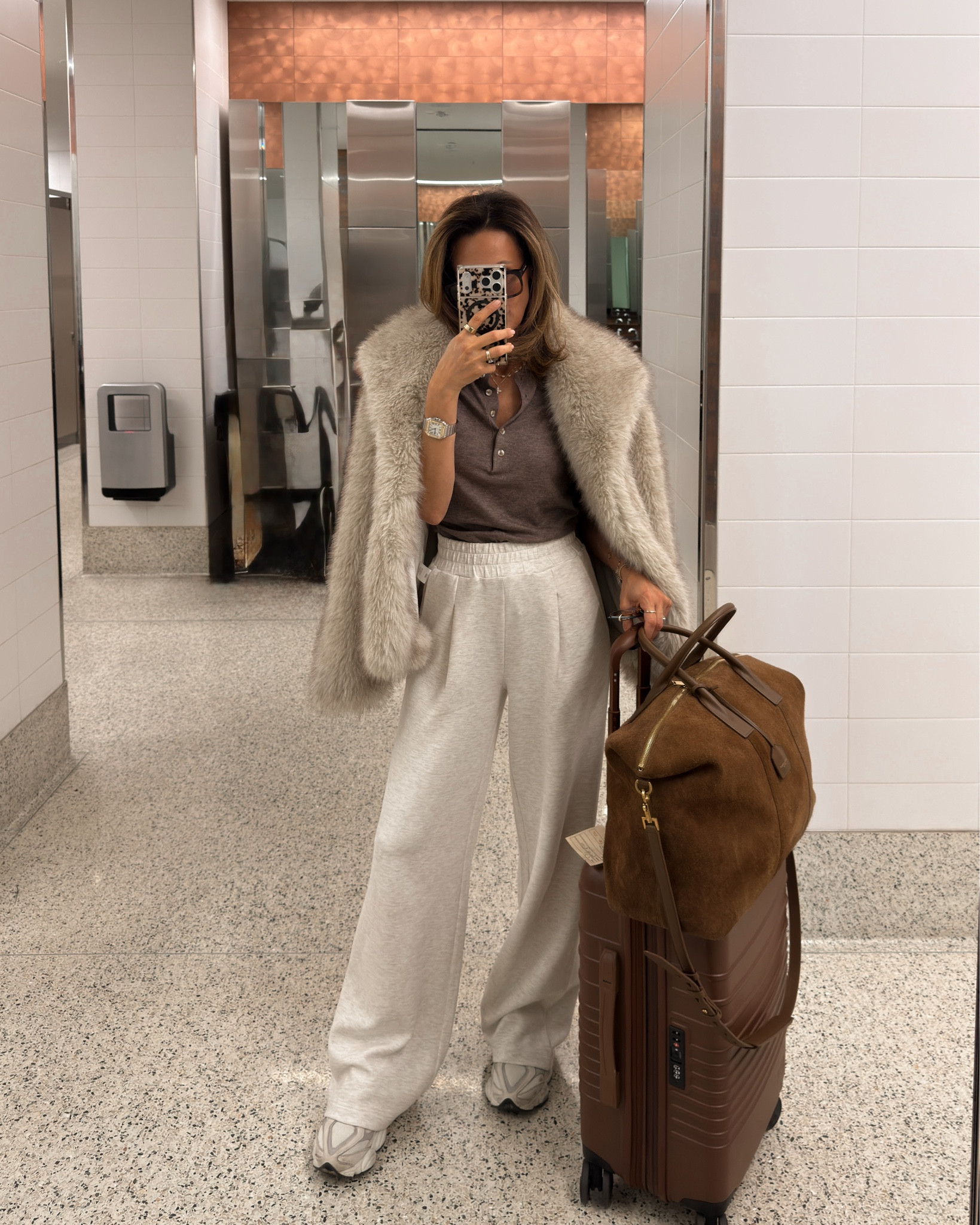 What I wore on my way back from Las Vegas. My pants are long size xs, and knit polo tee is super comfy also xs 
Fur coat, suede duffle bag and luggage I’ve been carrying everywhere! 

#LTKTravel #LTKootd #LTKOver40