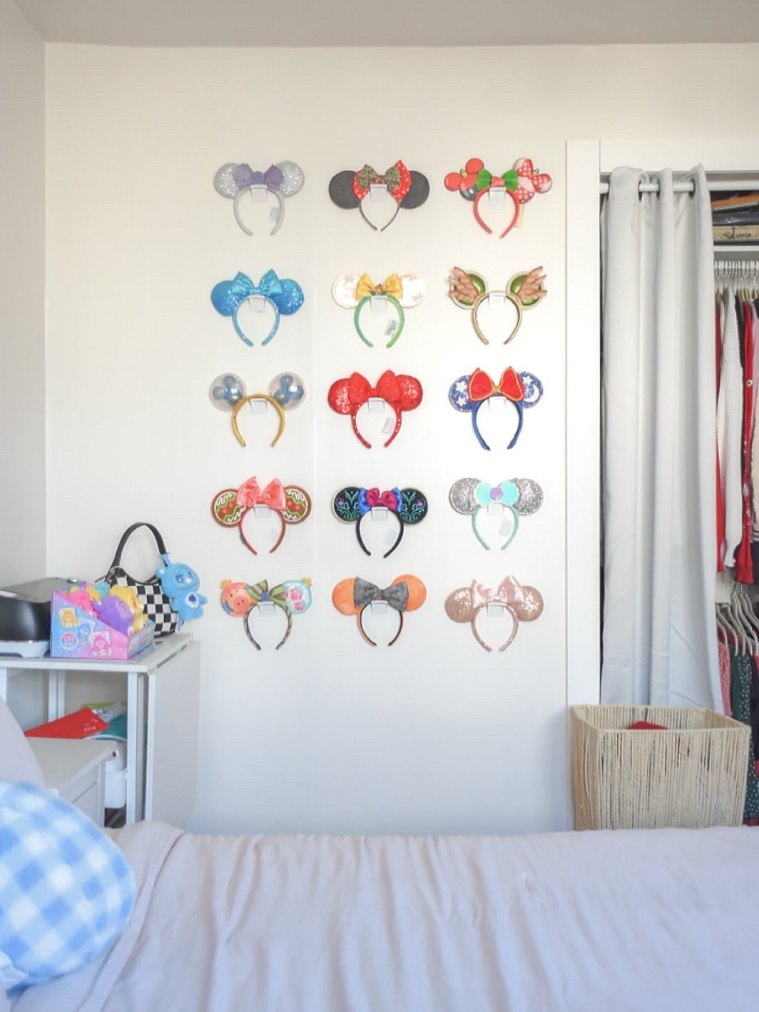 we’ve got ears, say cheers 🐭 our old office used to display our Disney collection favs- popcorn buckets, specialty sippers, Loungefly bags, and yes… ears 🫶🏻 but ever since we changed Hunter’s room to the nursery and our office to Hunter’s room, I’ve been struggling to find a place for everything 🥲 this wall used to be the other half of our closet (which is sadly now much smaller 🫠 ) but we had to close it up to give Hunter a closet soooooo hello blank space! I think I finally found its purpose.. ears! 

I tested it the design with putty first and now I’m officially ready to make it permanent .. maybe 🙈 What do we think?! Should I rearrange? 

I’m also back and forth on adding shelves for other pieces or hanging my Loungefly bags on the left… help me decide!! 🙏🏻 

✨ comment EARS and I’ll DM you a link to the ones I can find + the hooks I used 😊 #disneycreator #disneyears #minnieears #mickeyears #disneymom