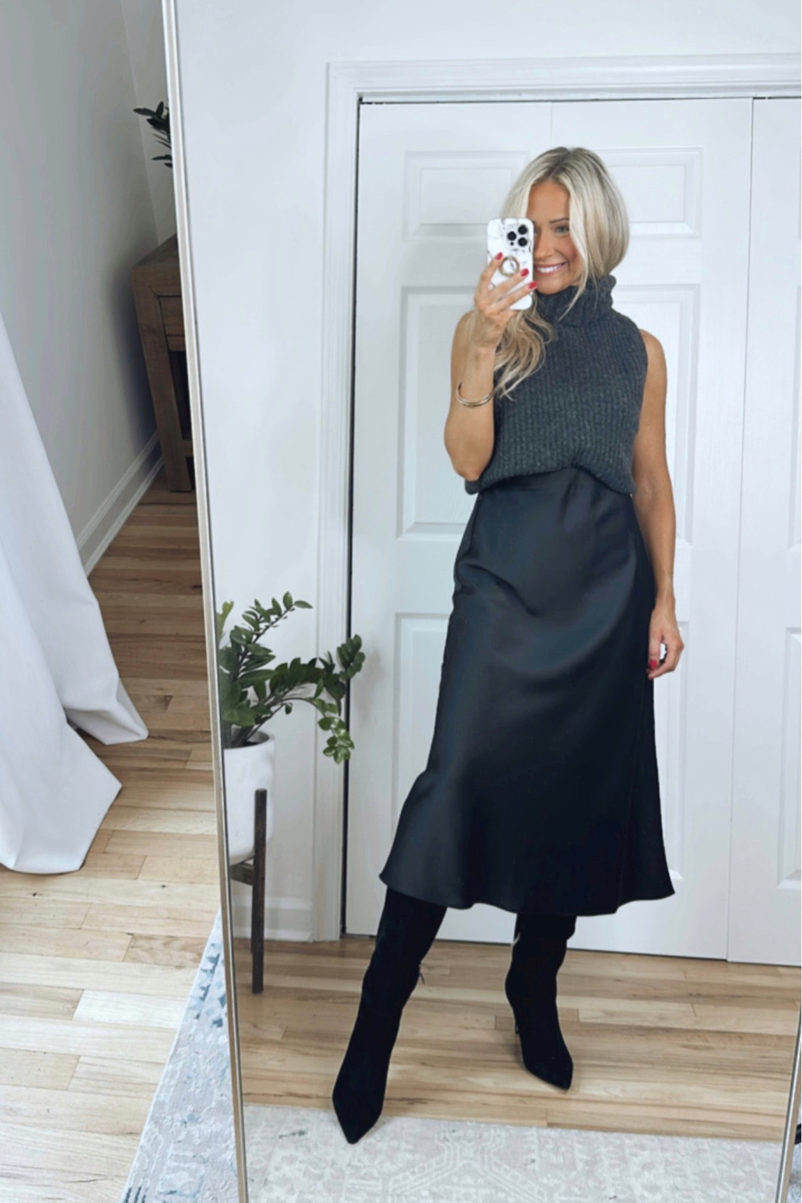 NSale work wear | Sizing info: Sleeveless turtleneck sweater runs TTS (meant to be an oversized fit), wearing a size small // Black satin midi skirt runs TTS, wearing a size small // Black suede knee high boots run TTS 

#LTKxNSale #LTKworkwear