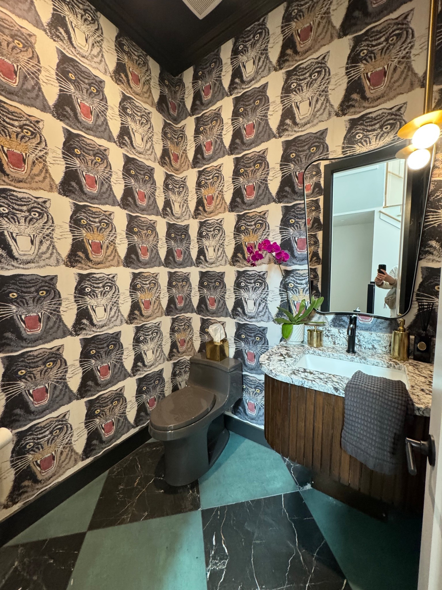 Never shy away from a bold powder bath! My clients were not afraid to go LOUD in here with fun wallpaper, a stained vanity, a grey toilet, modern black plumbing and a fun bathroom mirror. We love the end result! 

#LTKHome