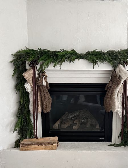 this years fireplace Christmas mantel 

used 6 6’ cedar garlands & pine + juniper + cedar branches for fullness in the top & peaks
topped with my stockings velvet & satin ribbon + bells! love the classic cascade & this cedar drapes and lays so so beautifully it’s my favorite!

#LTKfindsunder100 #LTKHoliday #LTKhome