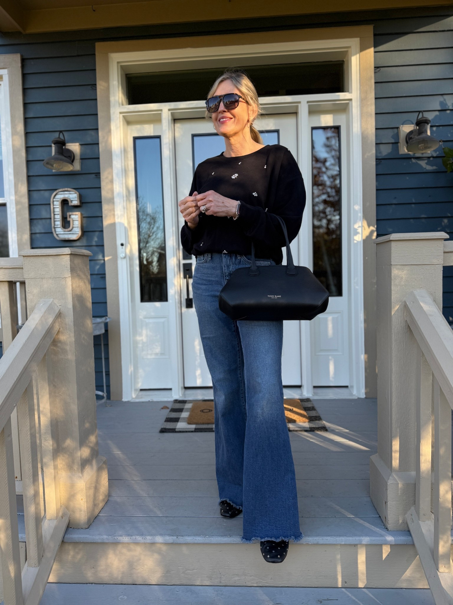 Casual holiday outfit idea. Rhinestone embellished sweatshirt from Loft wearing size small. NYDJ palazzo denim runs true to size wearing 00. 

Date night outfit, holiday outfit, mom looks, fashion over 40, wide leg denim, thanksgiving outfit, Teddy Blake handbagg

#LTKootd #LTKOver40 #LTKFindsUnder100
