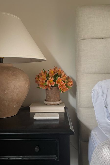 Guest bedroom nightstand vignette. I put a little glass inside the terra-cotta pot so I can use it for fresh flowers

#LTKstyletip #LTKhome