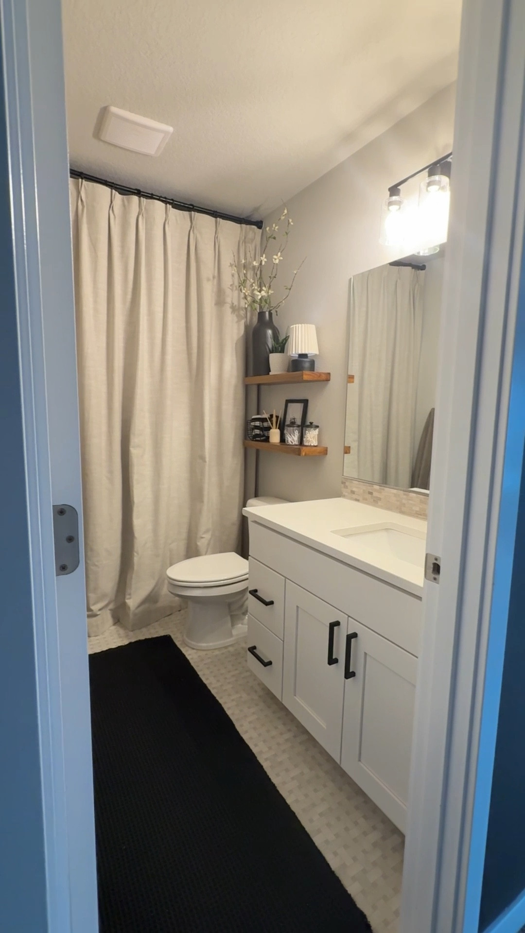 Raising the shower curtain to the ceiling totally elevated this small bathroom! I also made a few small changes with my decor! Kids bathroom. Boys Room. #neutralcurtains 

#LTKHome #LTKselfcare #LTKmomlife