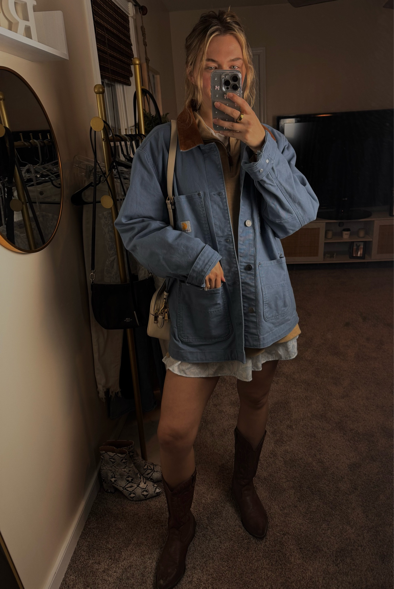 Cozy meets chic with this winter layered look! ❄️ The Carhartt chore coat is the perfect mix of rugged and stylish, while the beige oversized quarter-zip sweater adds that cozy touch for chilly days. 🧣 Pair it with a fun white and blue patterned mini skirt for a playful contrast and finish the look with the perfect white Coach crossbody bag for a pop of sophistication. ✨ Complete the outfit with the cafe-colored Tecovas boots for that extra bit of elegance and durability. Shop these essentials now to stay stylish, warm, and ready for any occasion! 🛍️ #WinterLayers #CarharttChoreCoat #OversizedSweater #CoachBag #TecovasBoots #MiniSkirtStyle #LTKFinds #CasualChic #CozyAndChic #WinterFashion 

#LTKStyleTip #LTKShoeCrush #LTKSaleAlert