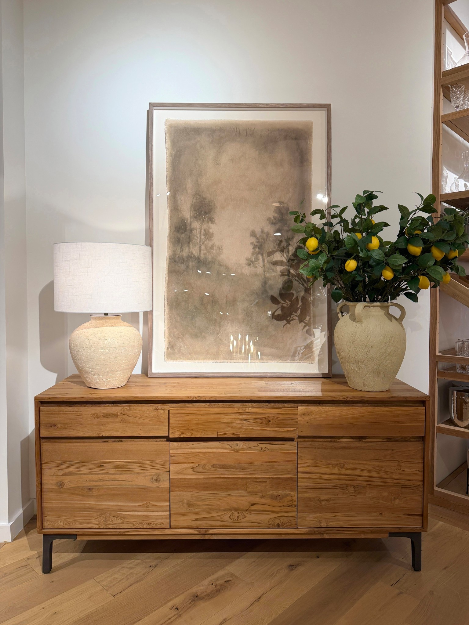 The Lakin 71” Teak Credenza from Crate & Barrel is such a standout with its repurposed teak wood and rich natural grain. 🤎 The streamlined design with hidden self-pulls keeps the look clean and modern, while the antiqued metal legs add a subtle mixed-material contrast.✨ It offers generous storage with drawers and cabinets—perfect for keeping everyday essentials tucked away while letting the beautiful wood take center stage. Styled here with the “Sweet Nostalgia” framed wall art by Tessa Brown, a table lamp, and a simple vase for a warm, collected look. ☺️ Linked this credenza and similar styles to shop!  #CrateAndBarrel #Credenza #LivingRoomInspo

#LTKSaleAlert #LTKHome